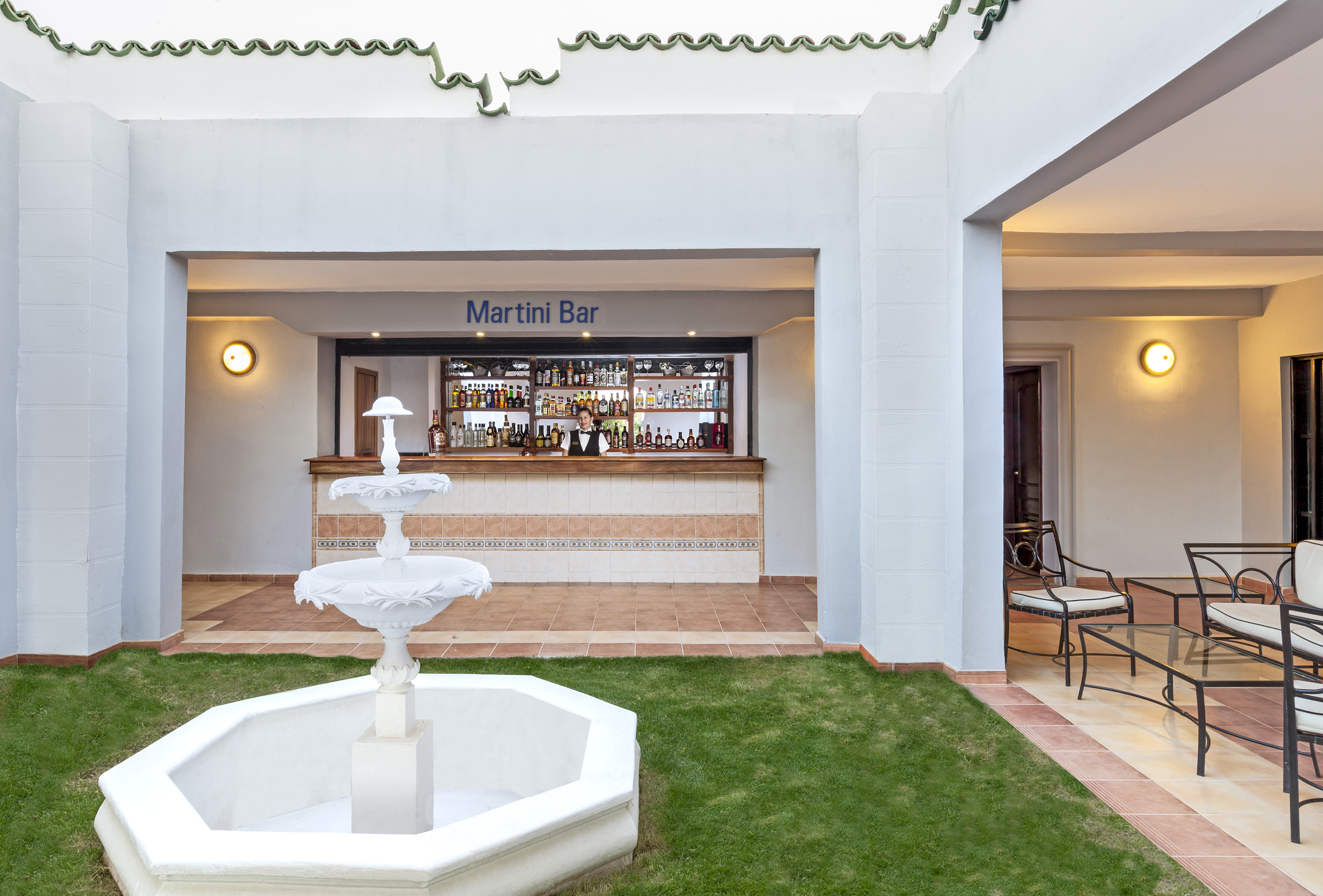 a fountain in front of a bar