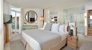a bedroom with a large bed and a mirror