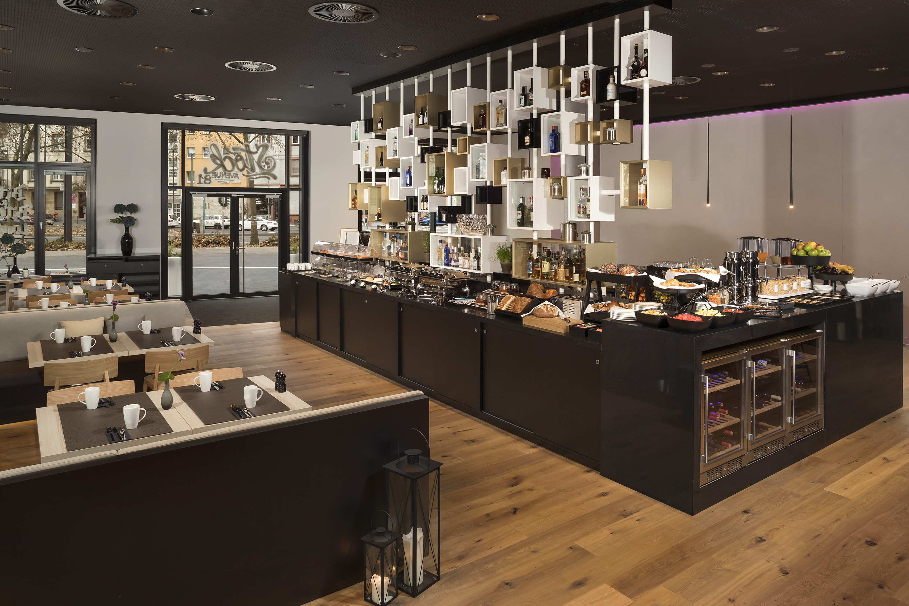 Modern hotel restaurant interior with breakfast buffet, food, and stylish dining.