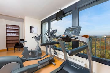 a room with exercise machines and a window