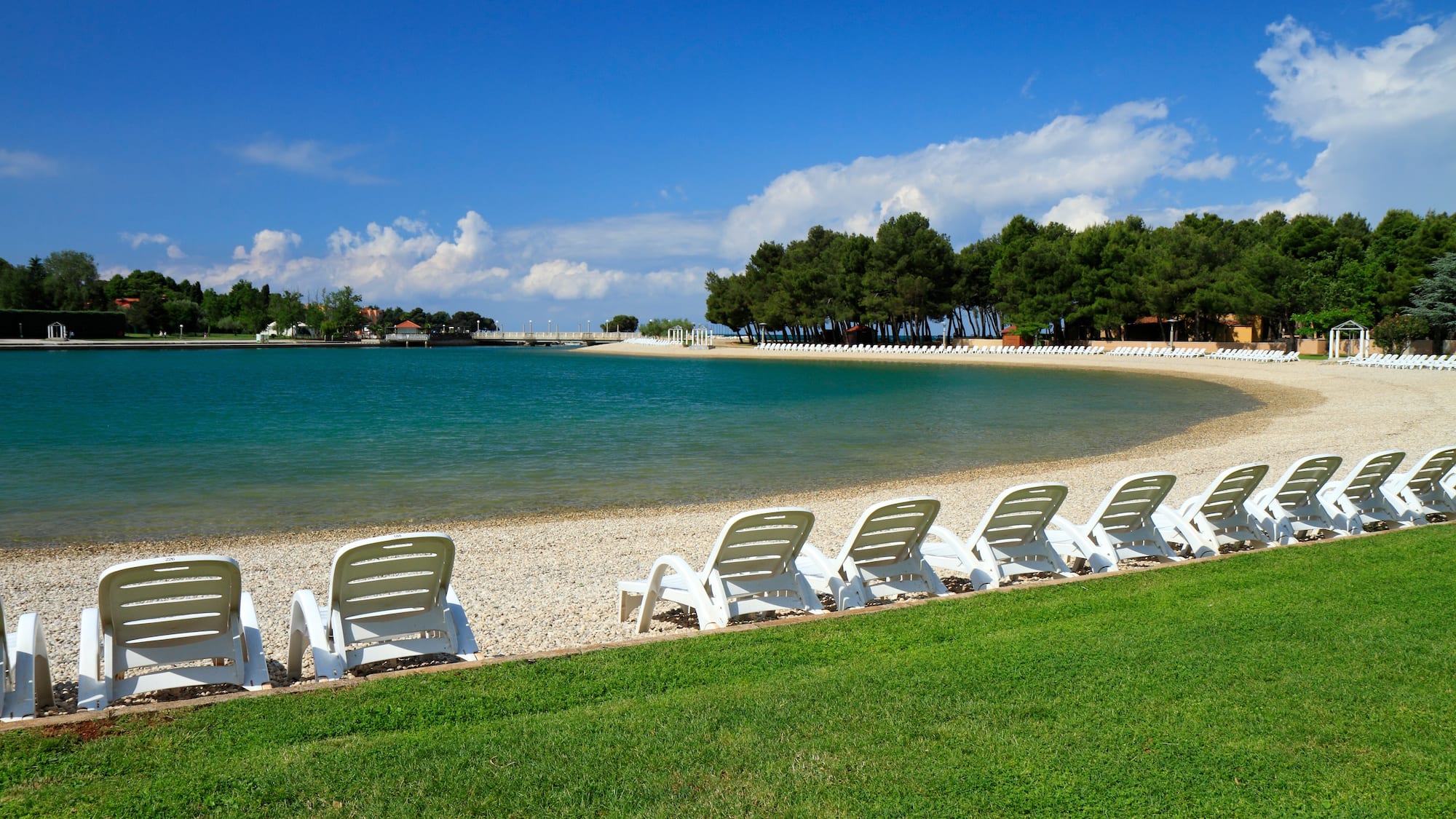 a row of chairs on a beach