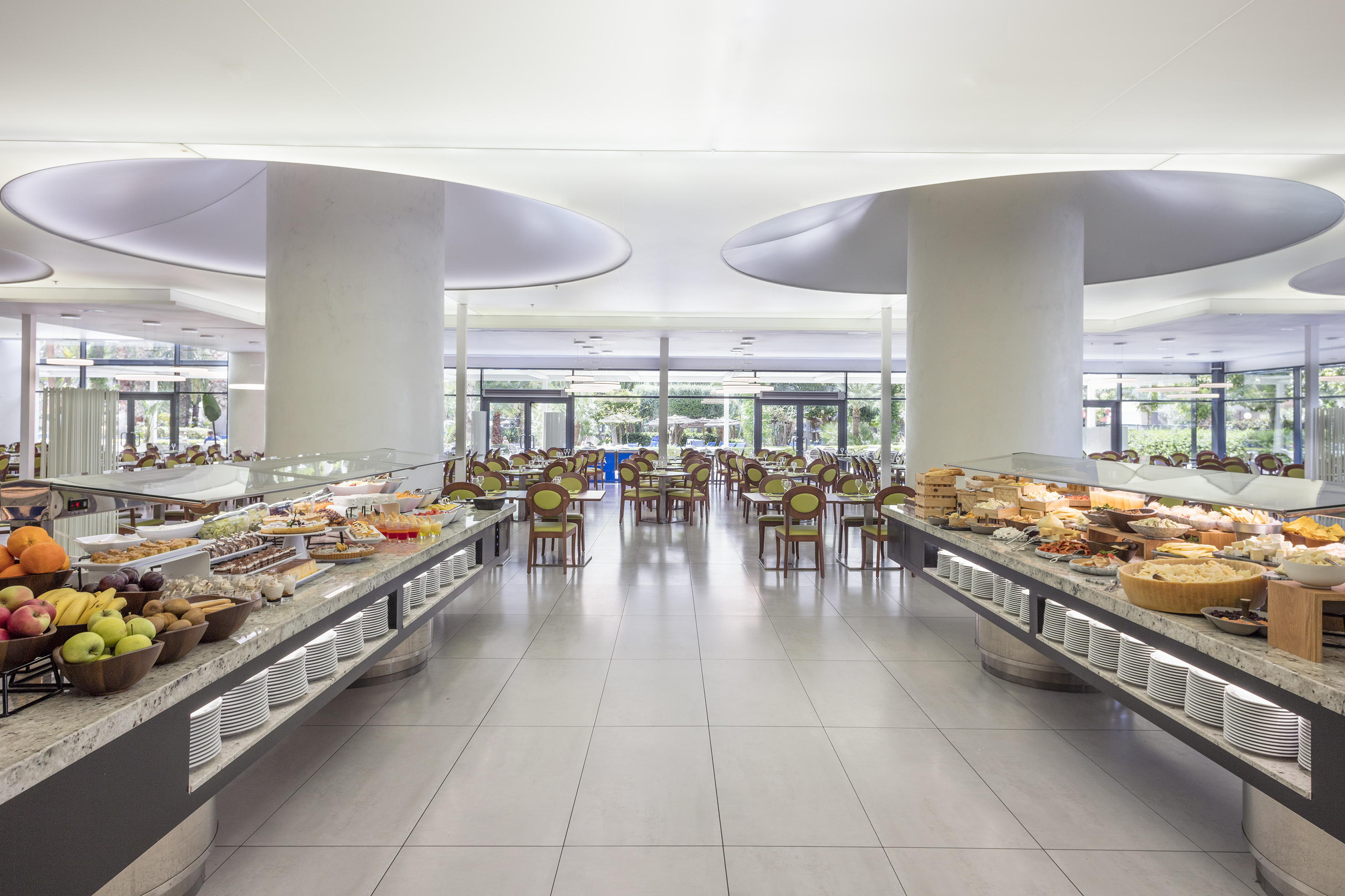 Bright modern buffet restaurant with food counters and dining area.