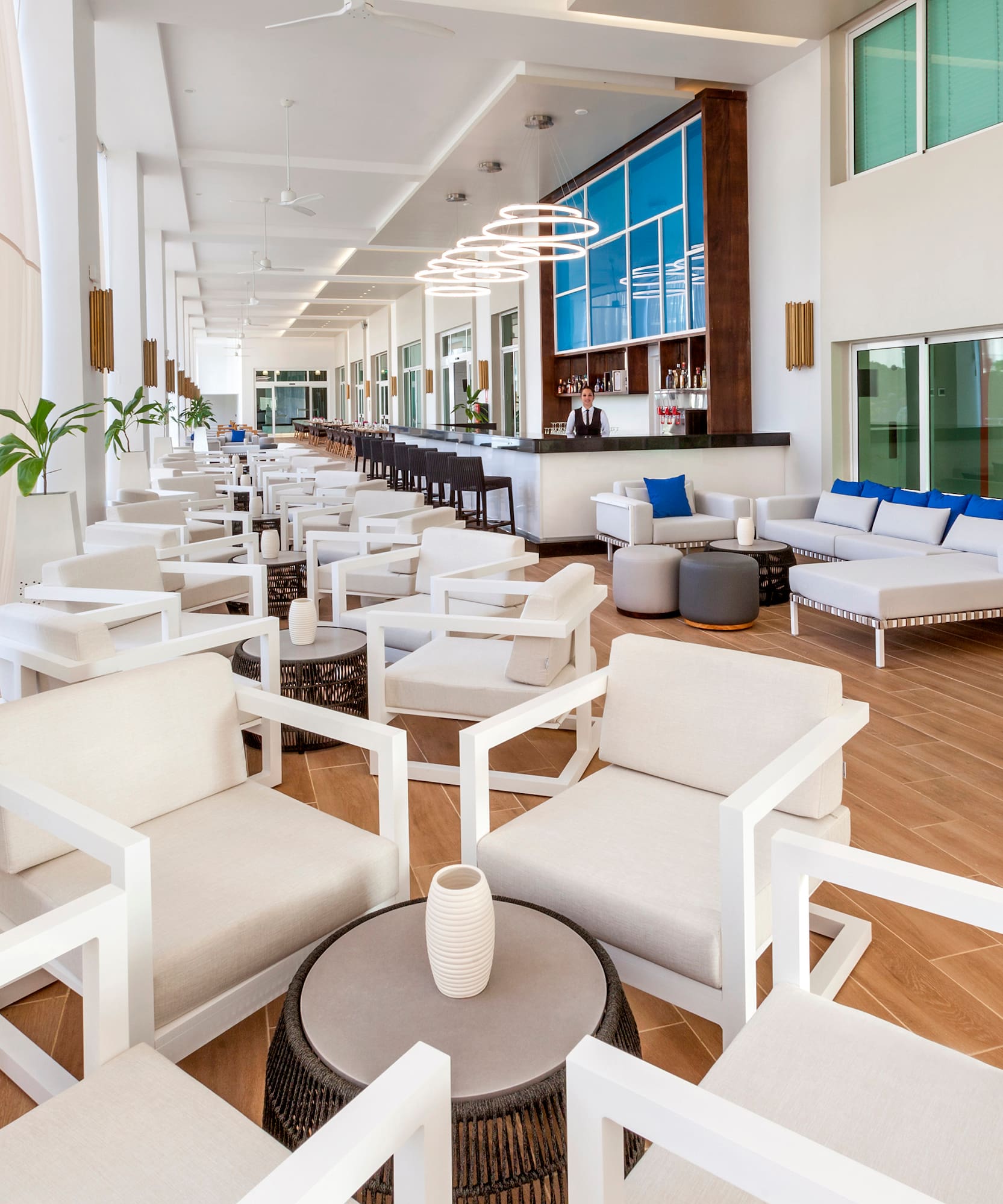 a room with white chairs and tables