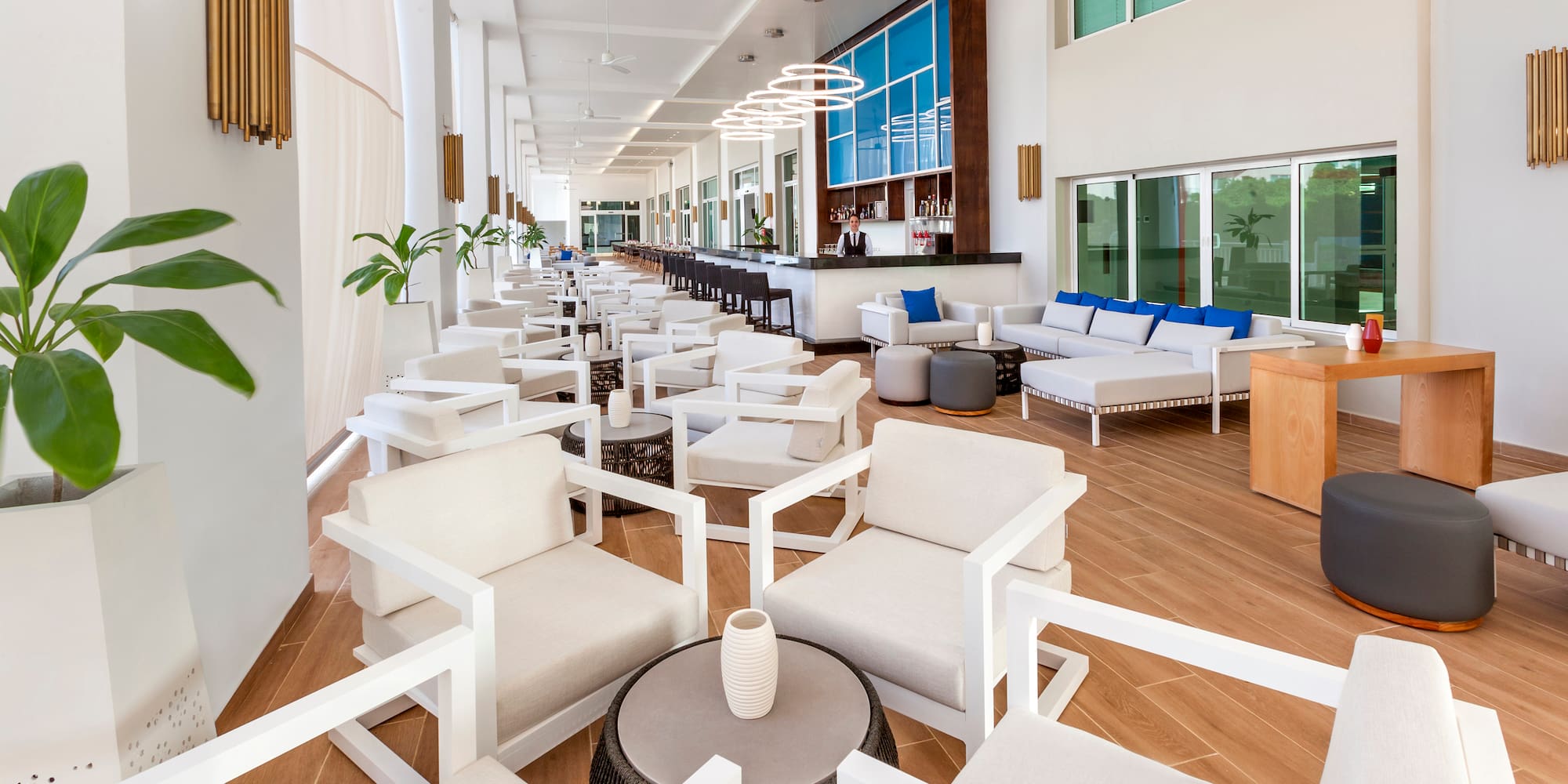 a room with white chairs and tables