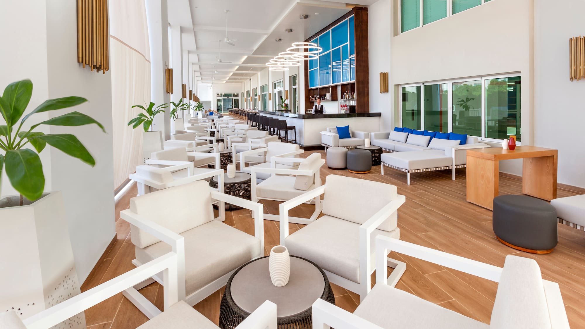 a room with white chairs and tables