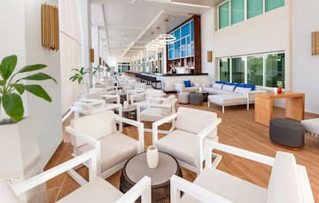 a room with white chairs and tables