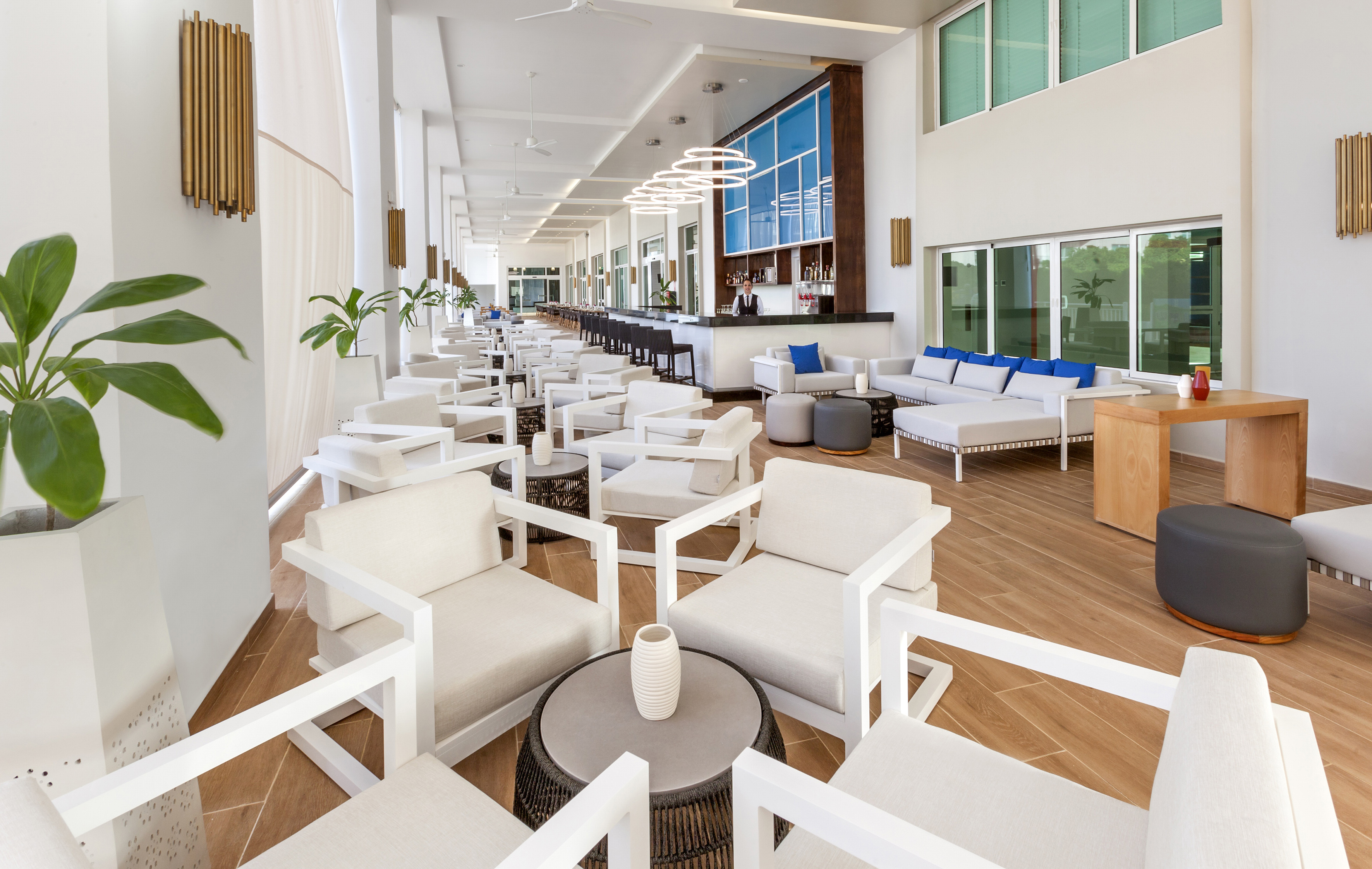 a room with white chairs and tables