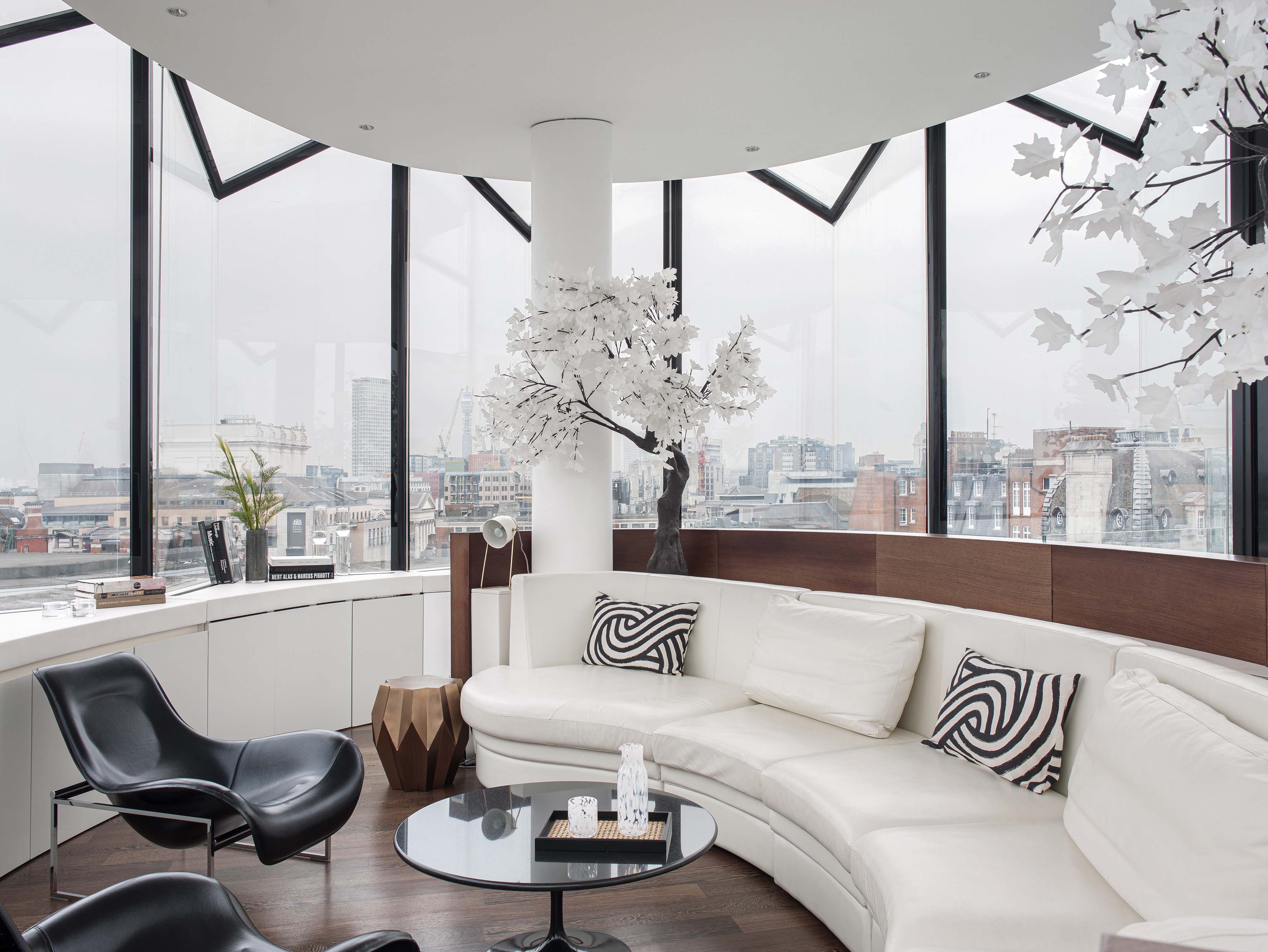 a room with a white couch and a black table