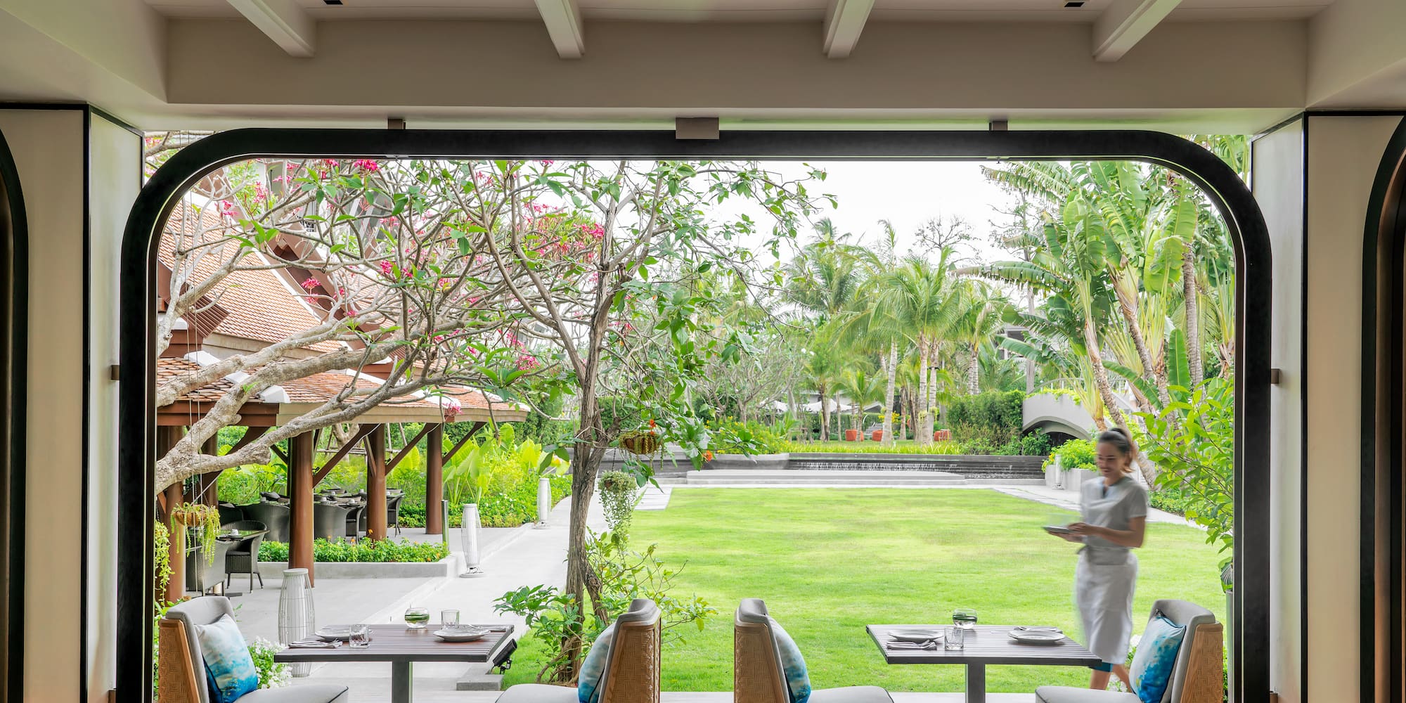 a woman standing at a table outside