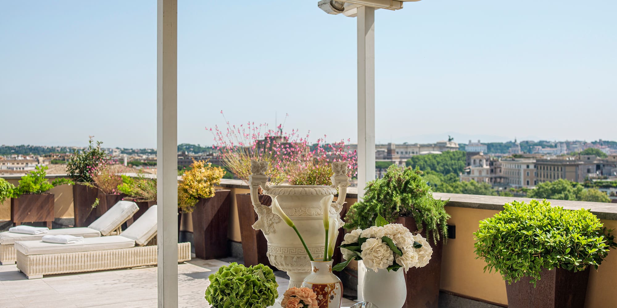 a white table with flowers and plants on it