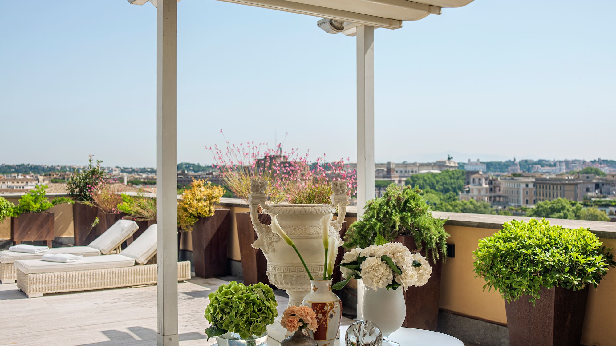 a white table with flowers and plants on it
