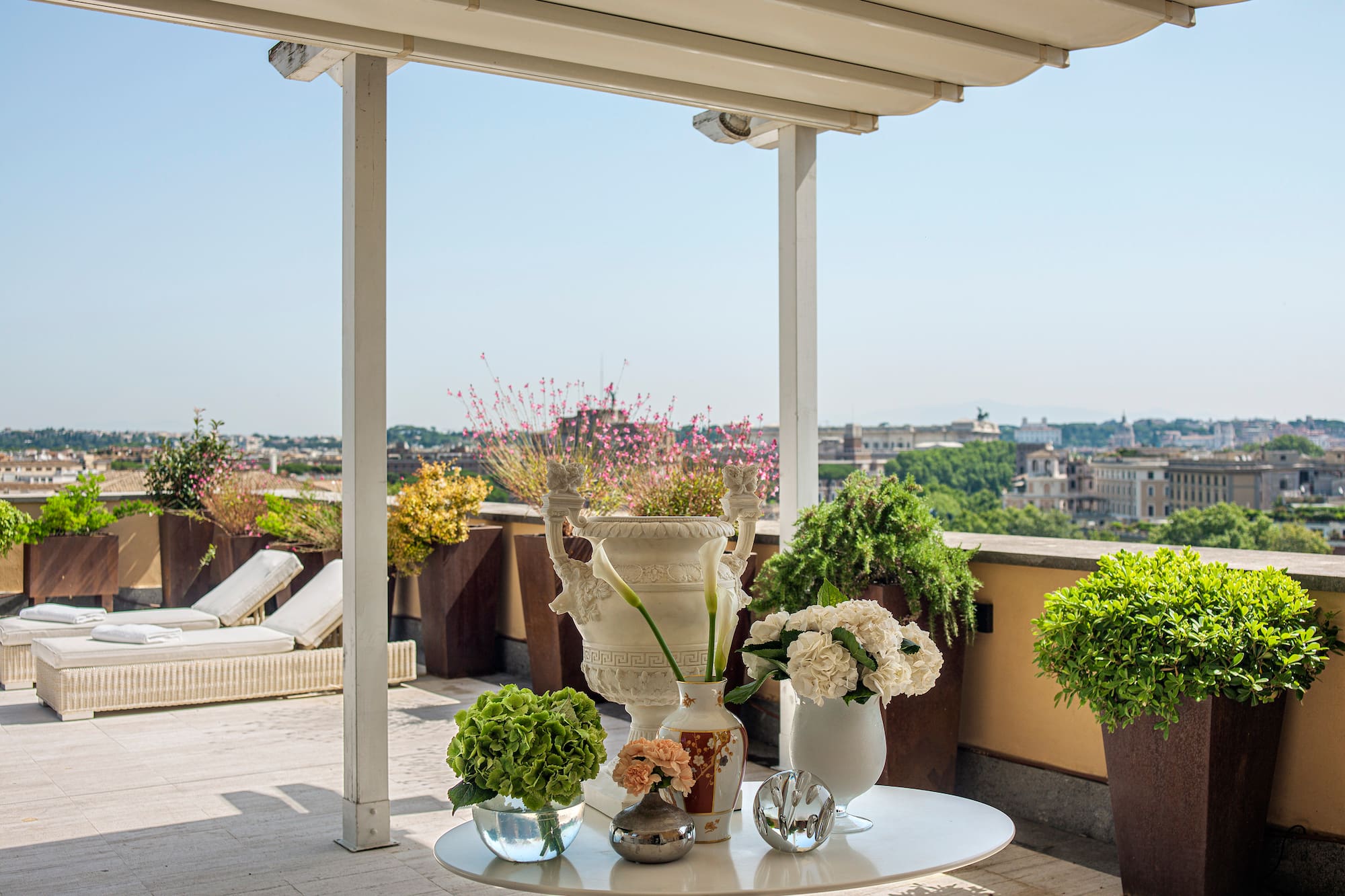a white table with flowers and plants on it