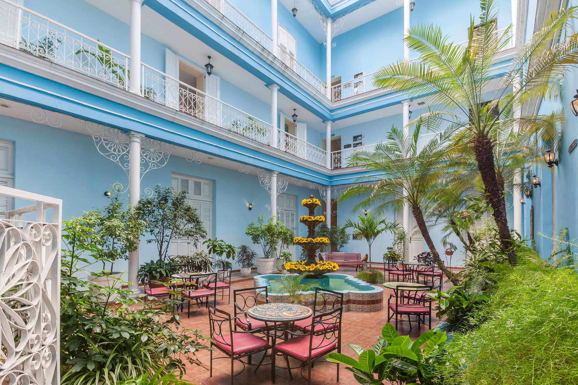 a courtyard with patio furniture and plants