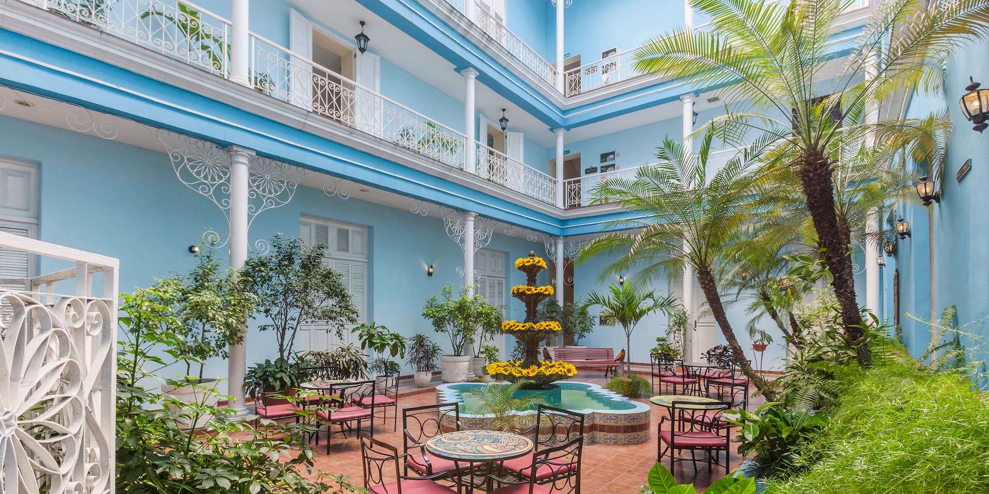 a courtyard with patio furniture and plants