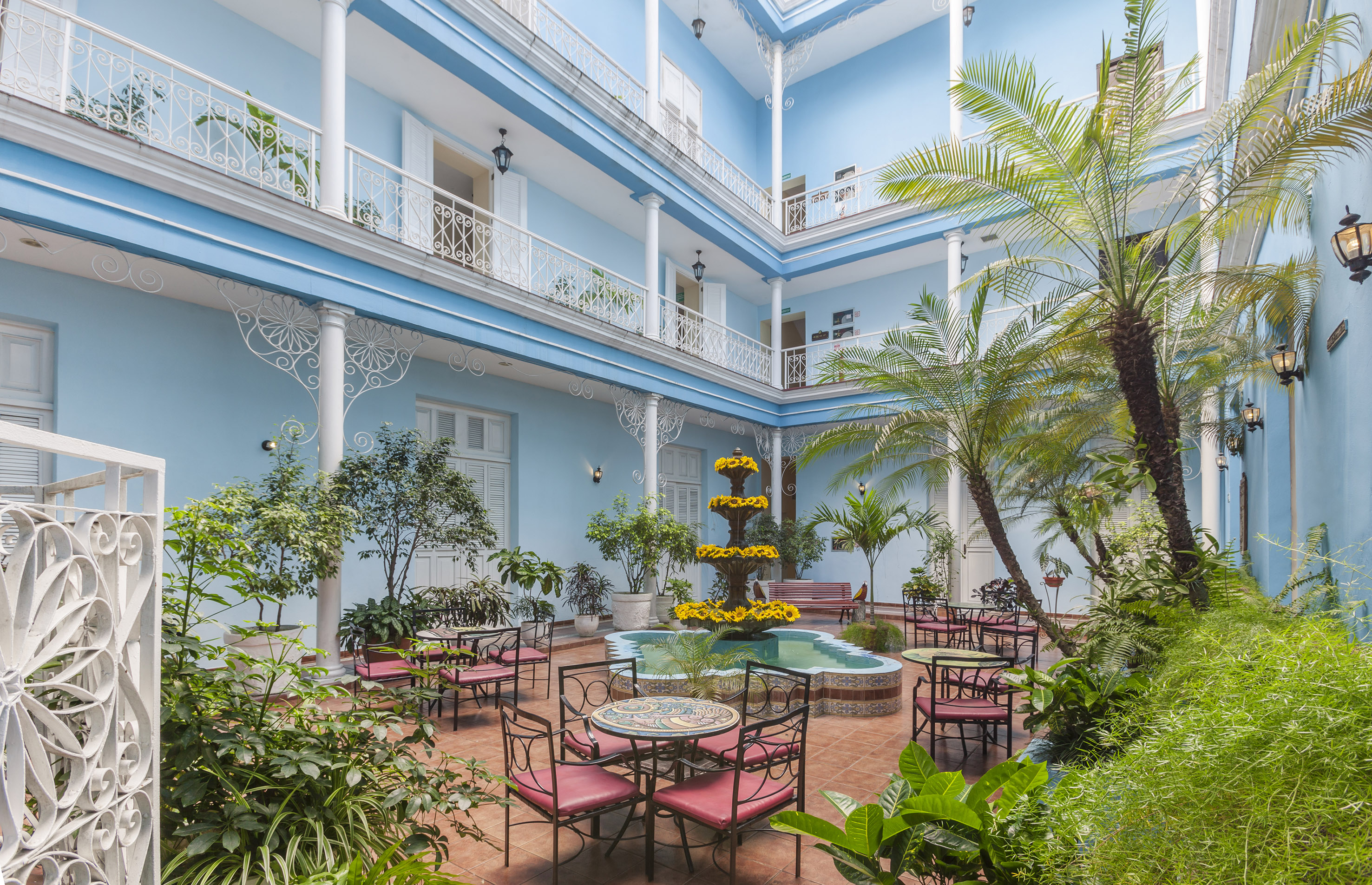 a courtyard with patio furniture and plants