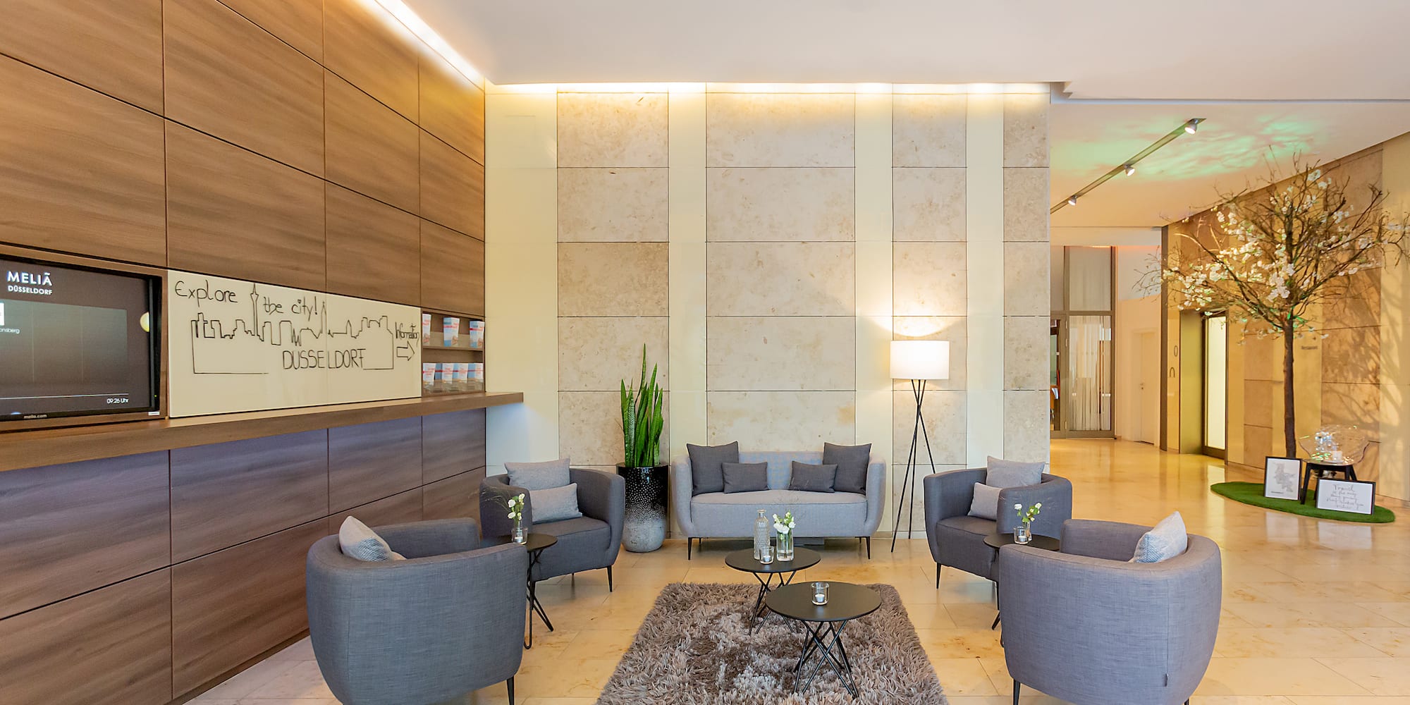 a lobby with a group of chairs and a rug