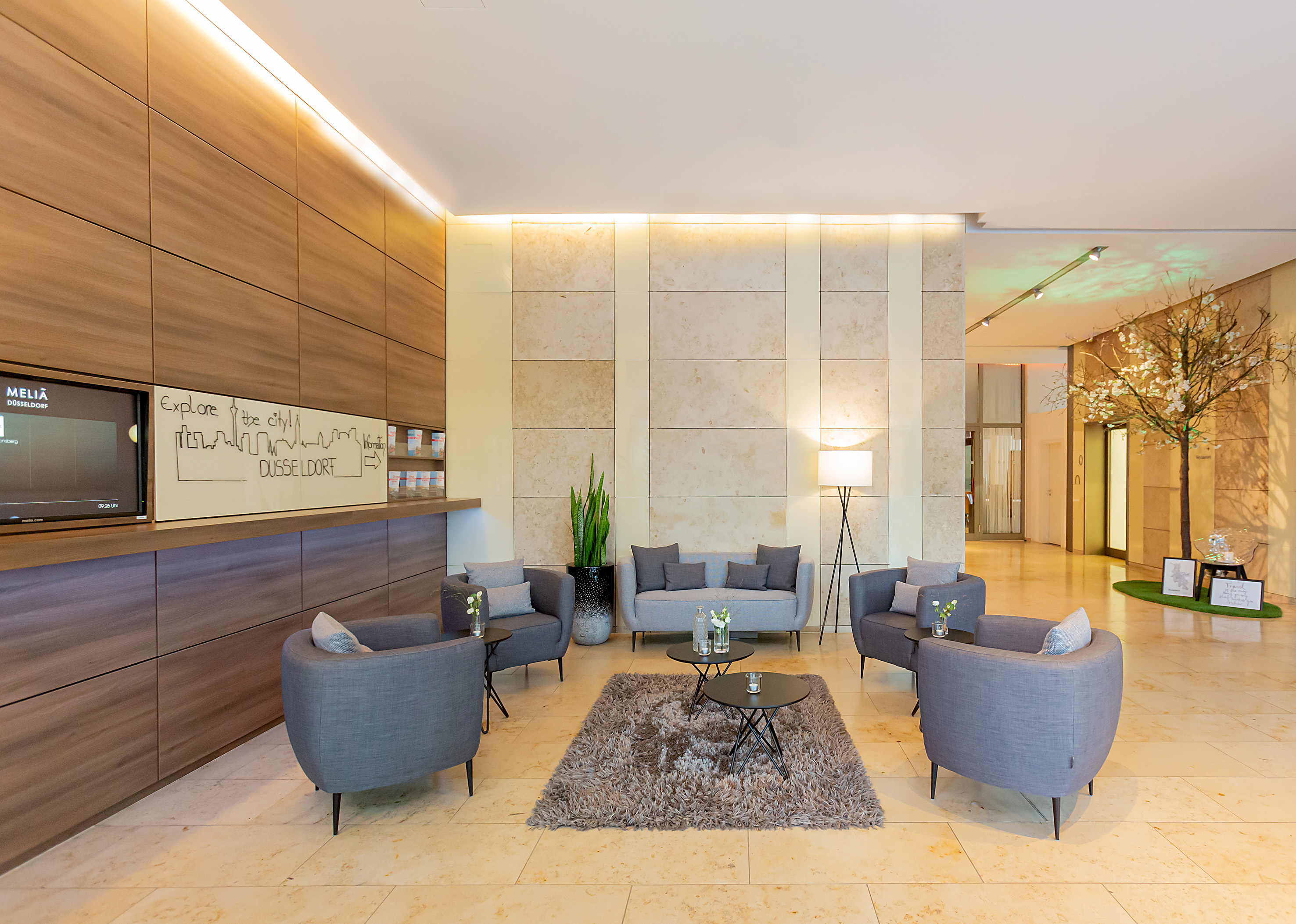 a lobby with a group of chairs and a rug