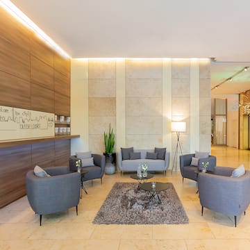 a lobby with a group of chairs and a rug