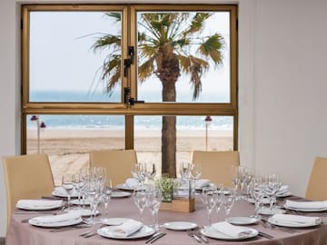 a table set for dinner with a beach view