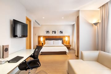a room with a bed and a tv