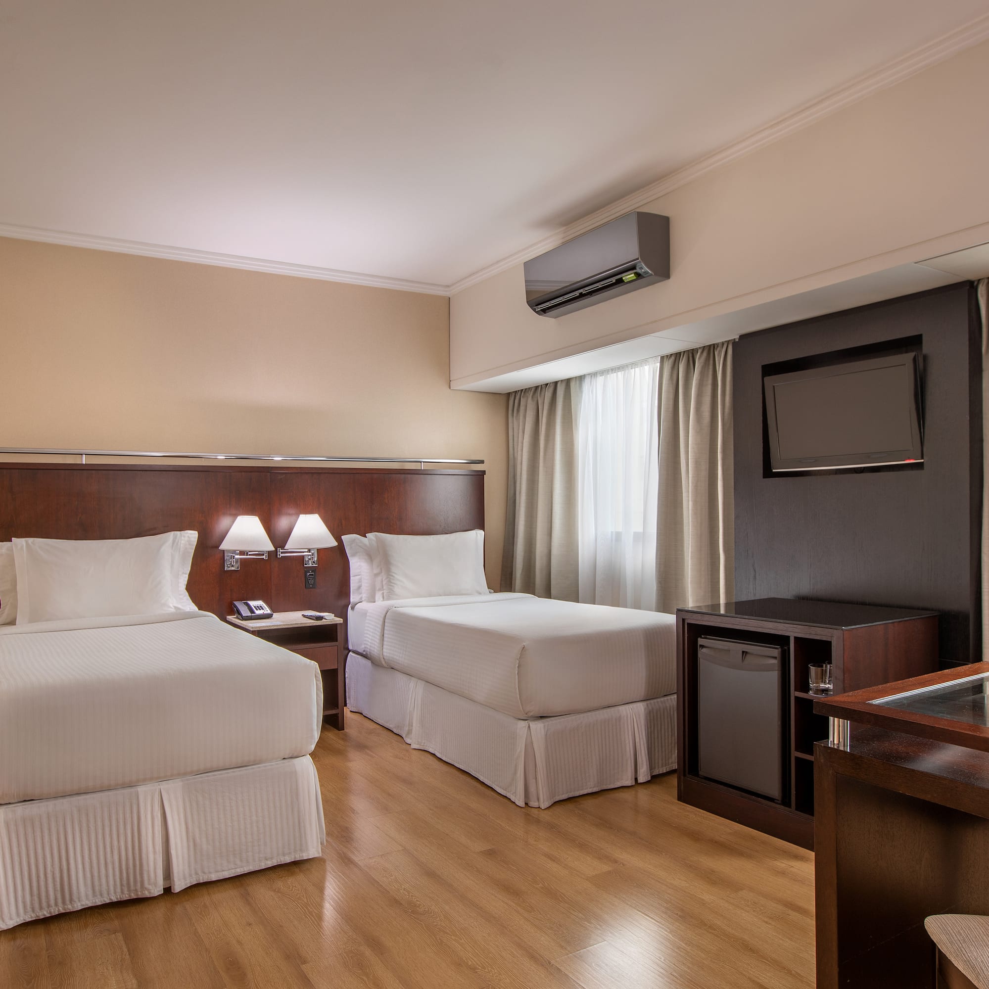 a room with two beds and a tv