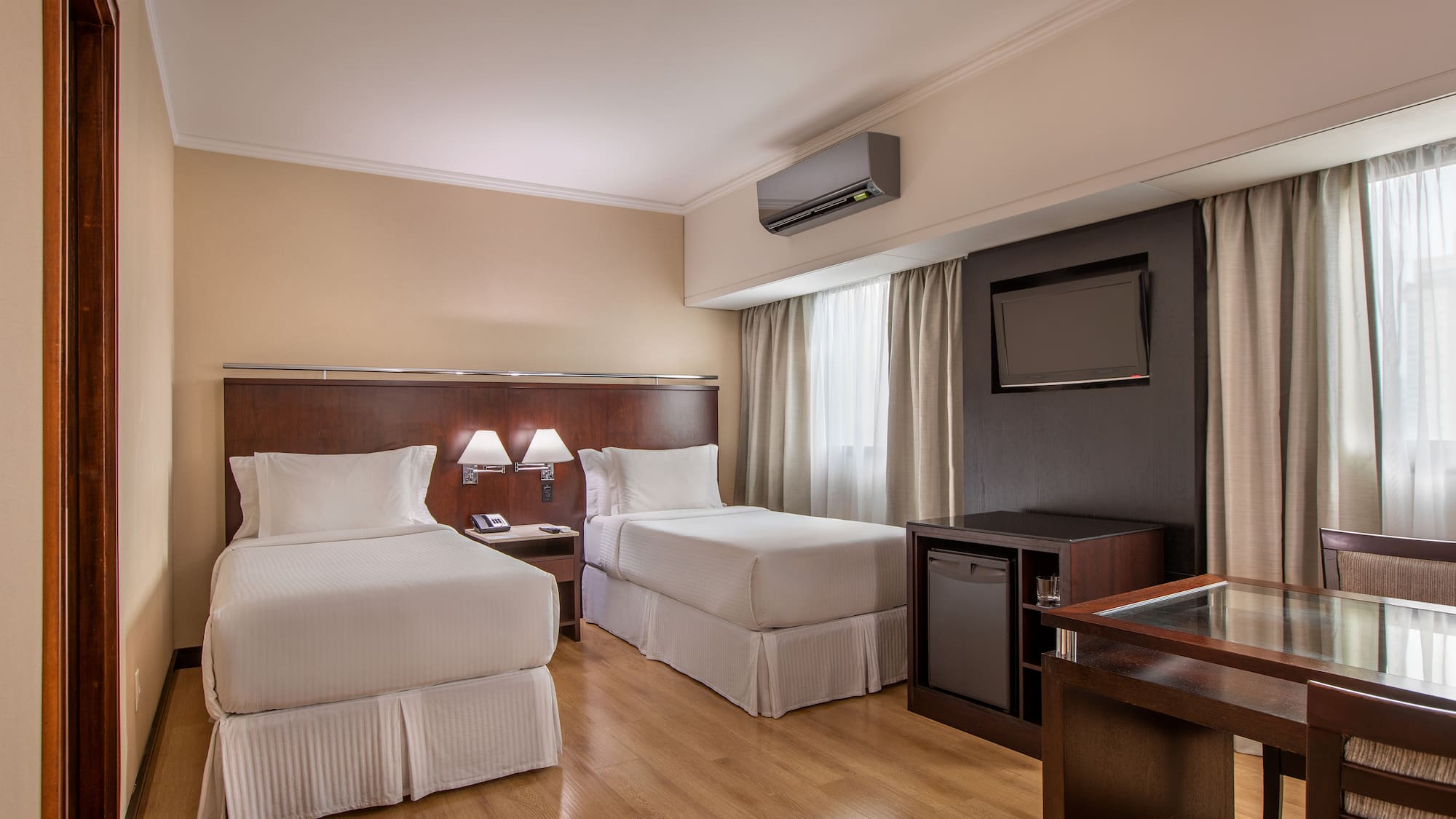 a room with two beds and a tv