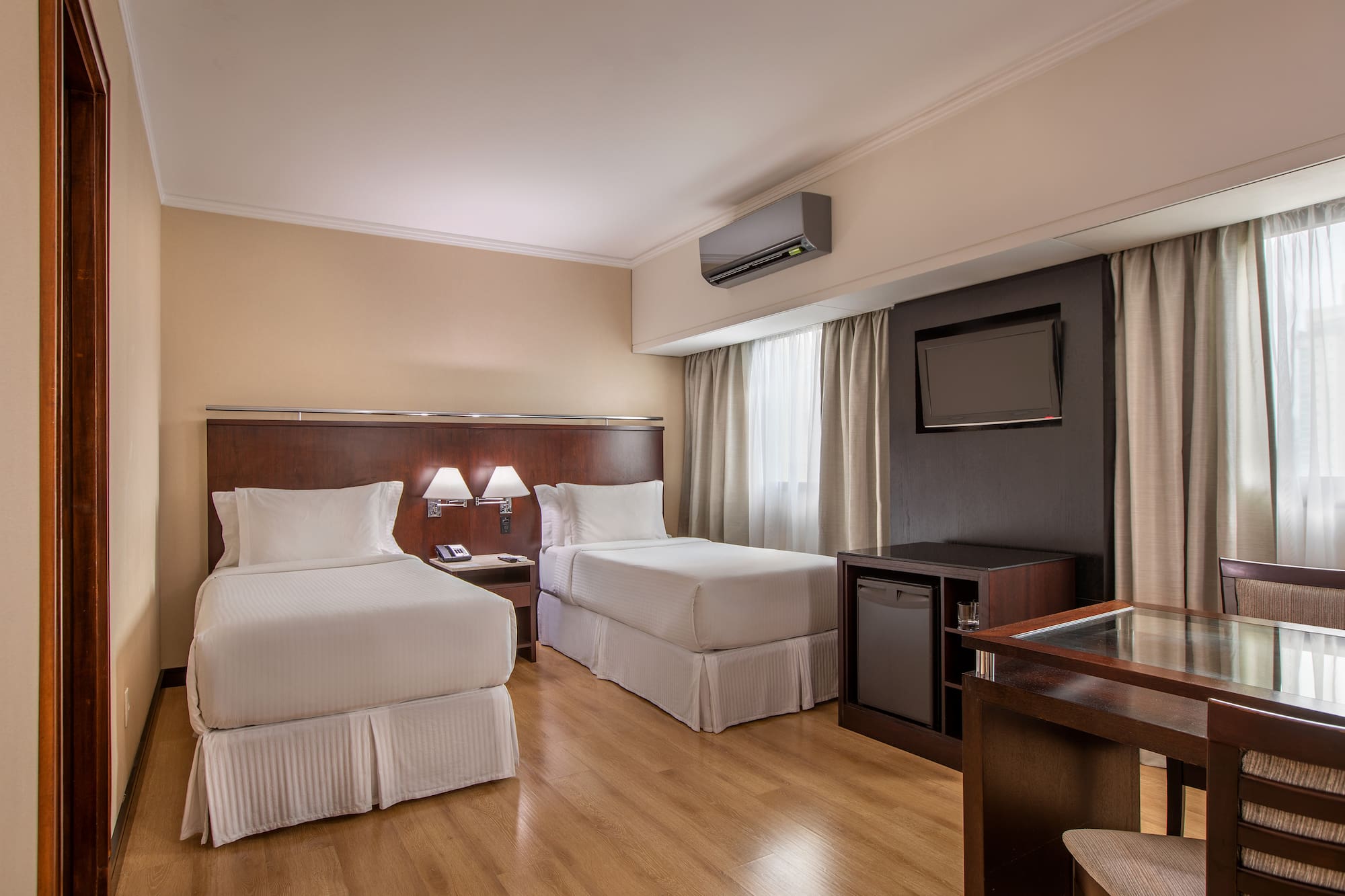 a room with two beds and a tv