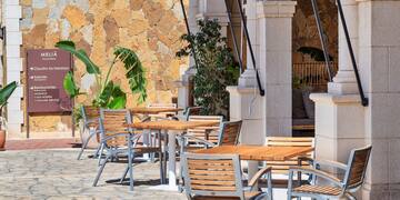 tables and chairs outside a building