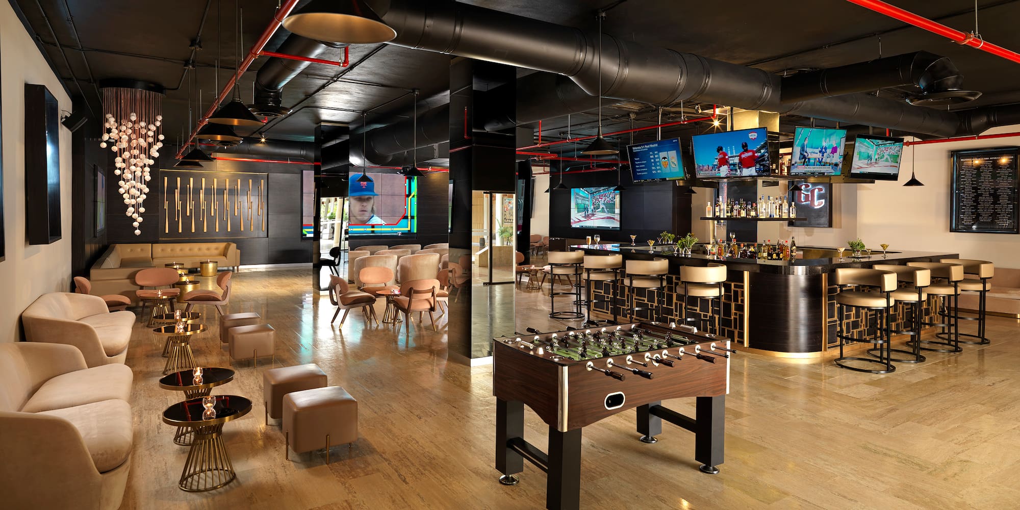 a room with a foosball table and tables and chairs