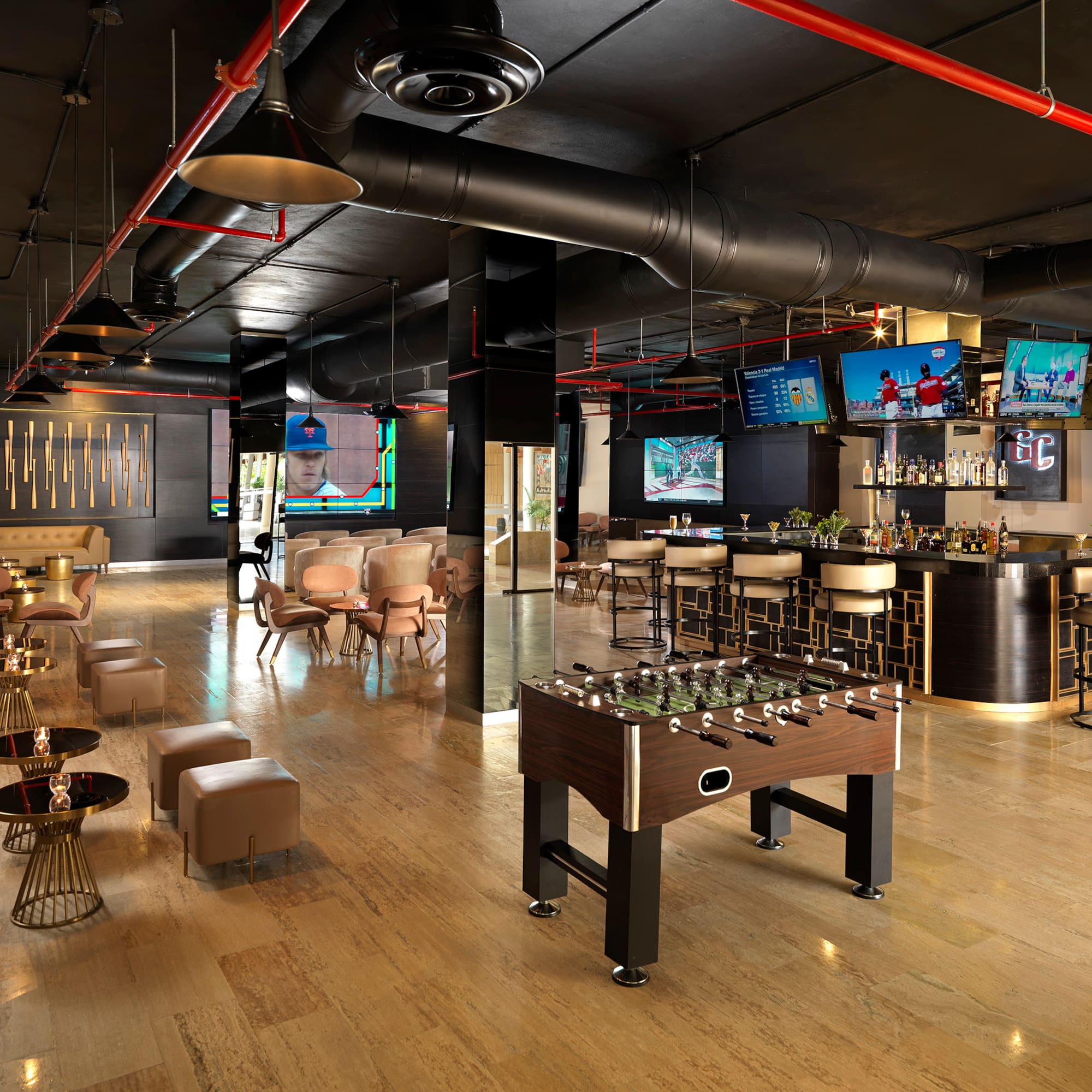 Upscale lounge bar with foosball, sports TVs, and contemporary seating.