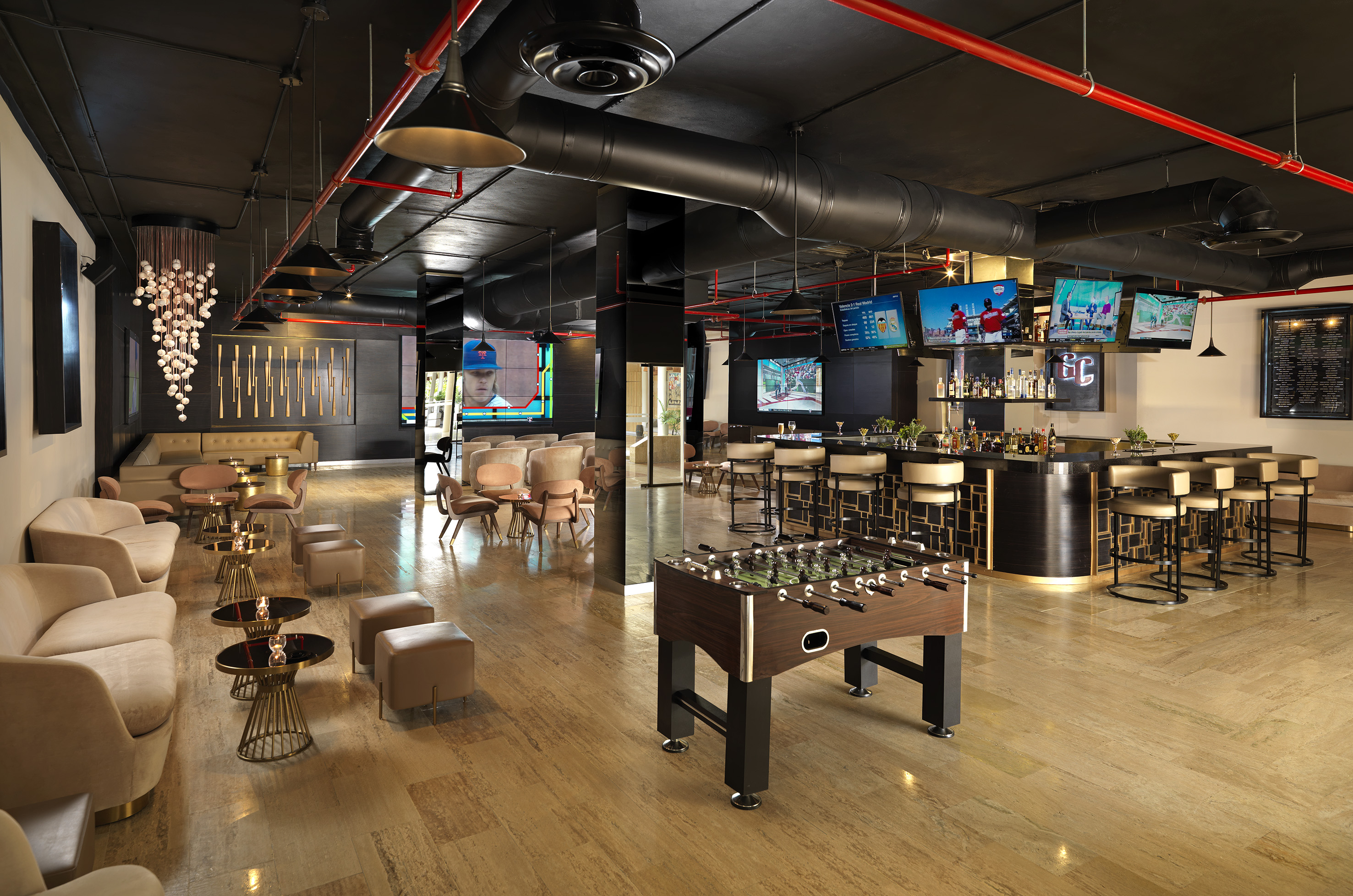 Upscale lounge bar with foosball, sports TVs, and contemporary seating.