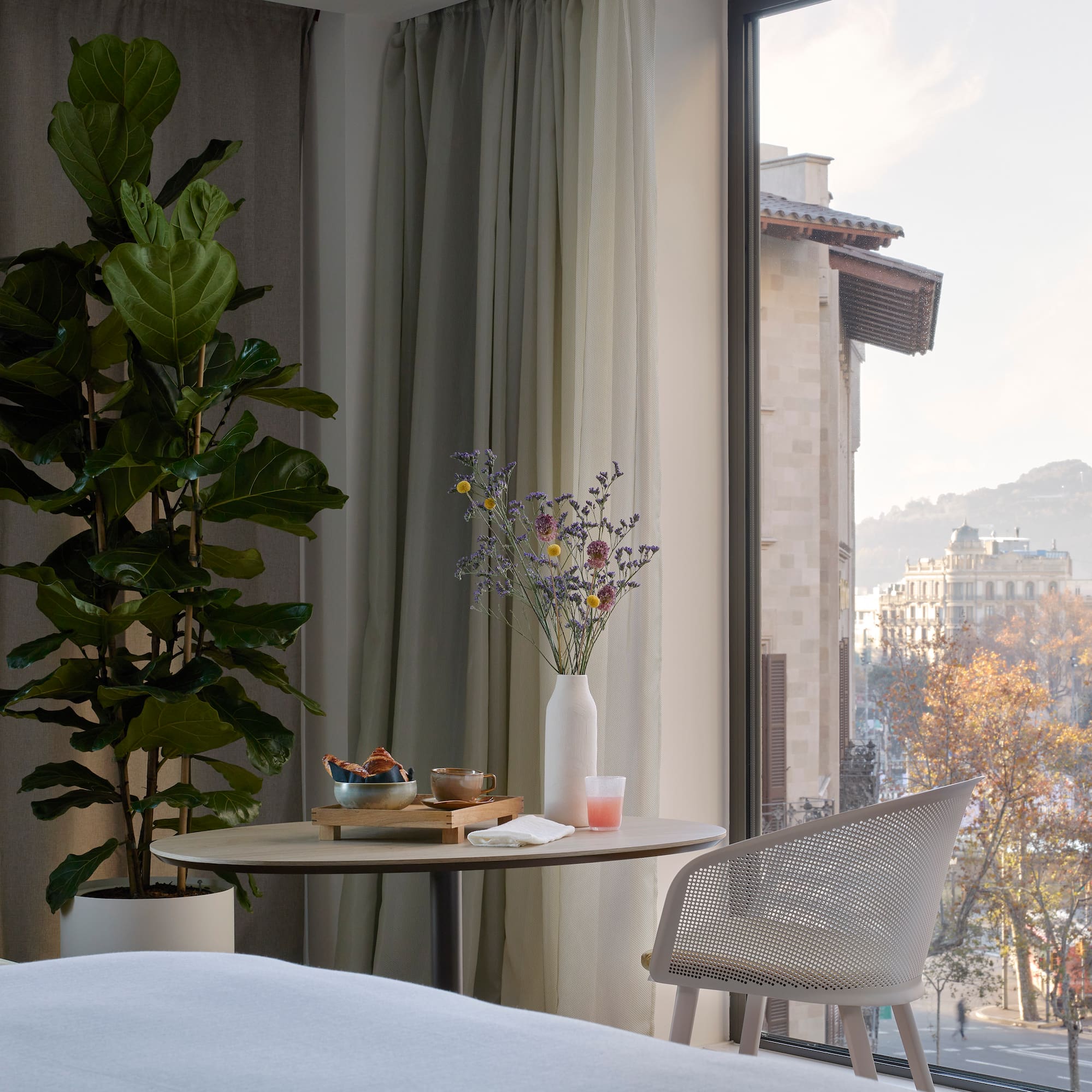 a room with a table and chair and a plant