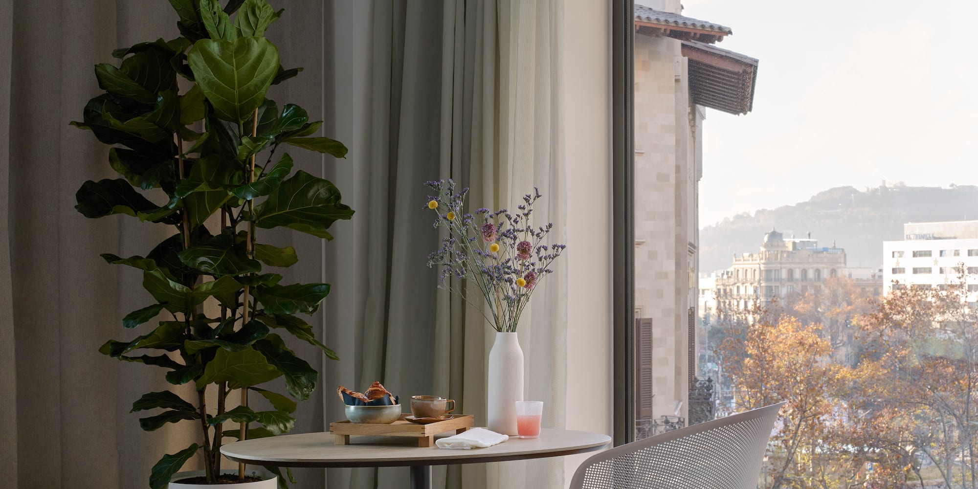 a room with a table and chair and a plant