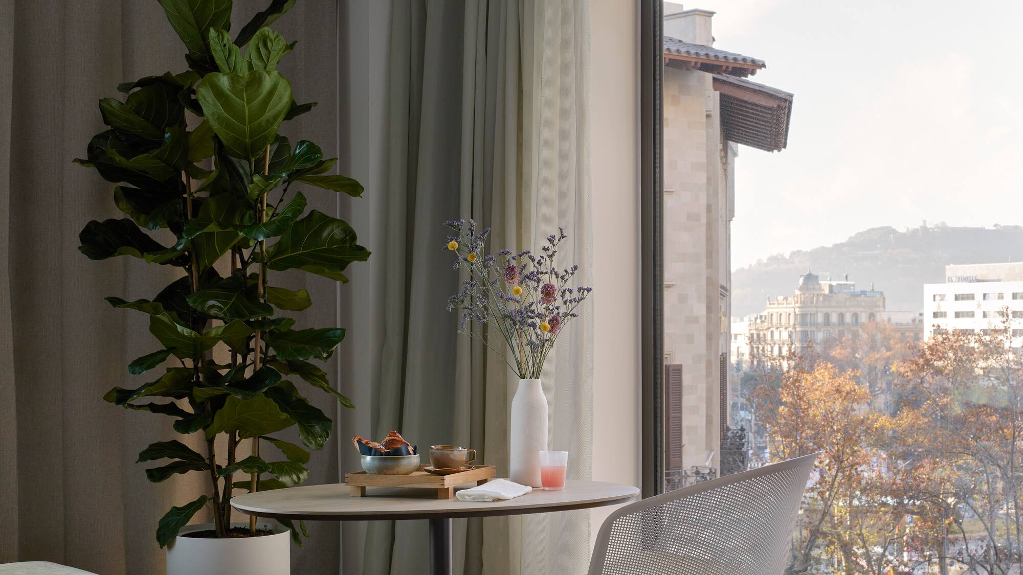 a room with a table and chair and a plant