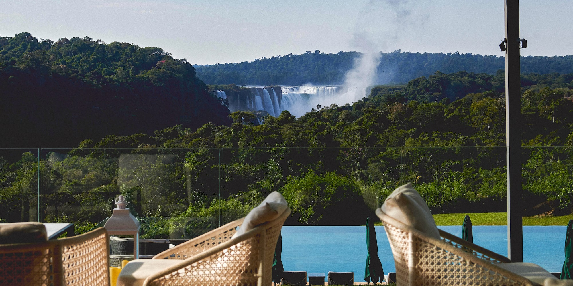 chairs on a balcony overlooking a waterfall