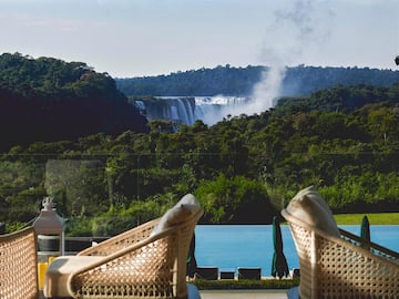 chairs on a balcony overlooking a waterfall