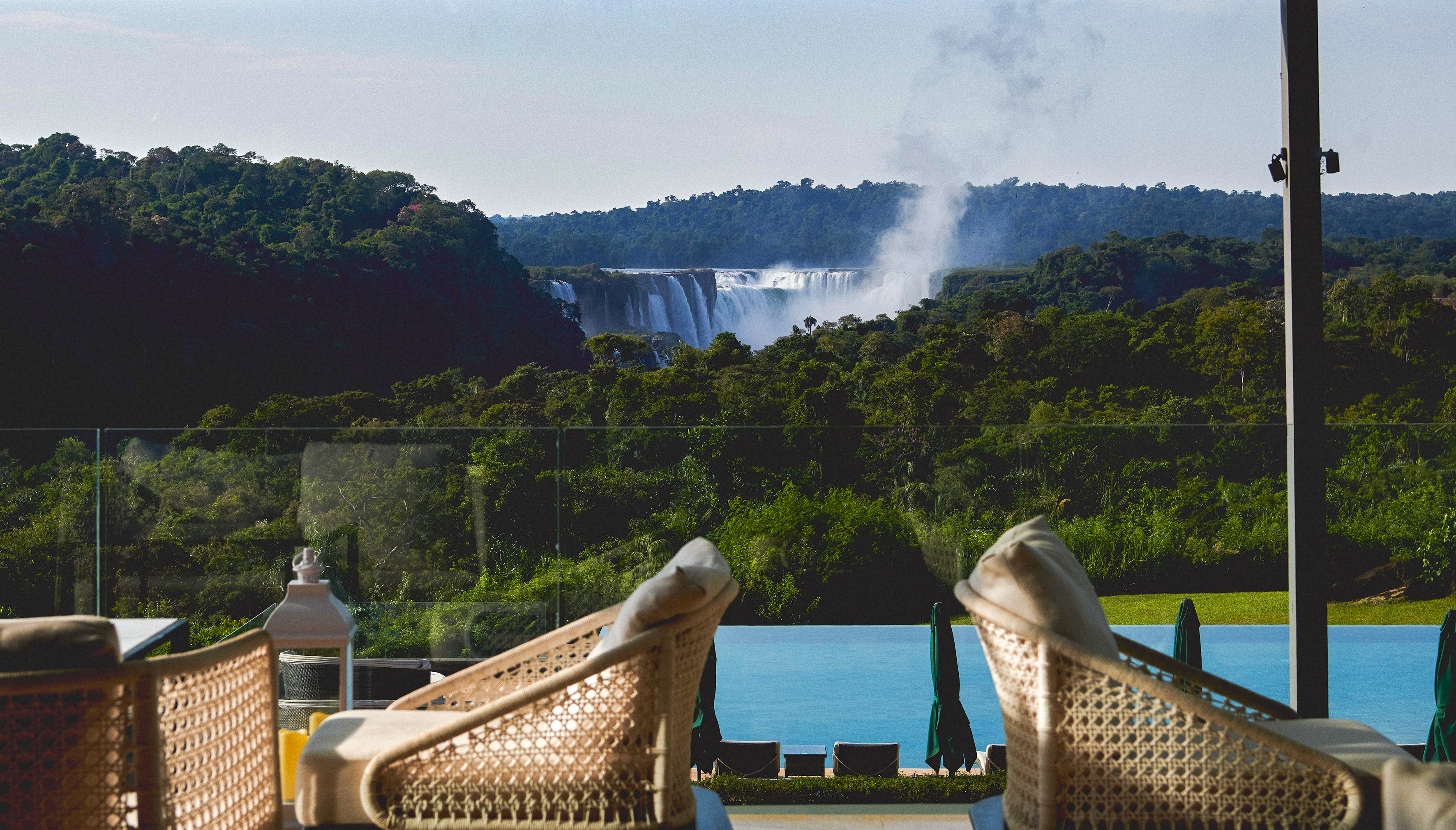 chairs on a balcony overlooking a waterfall