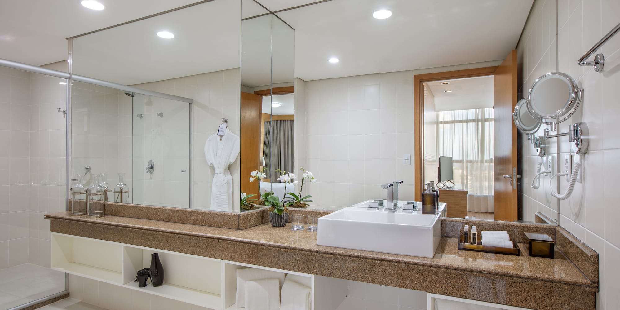 a bathroom with a large mirror and a sink