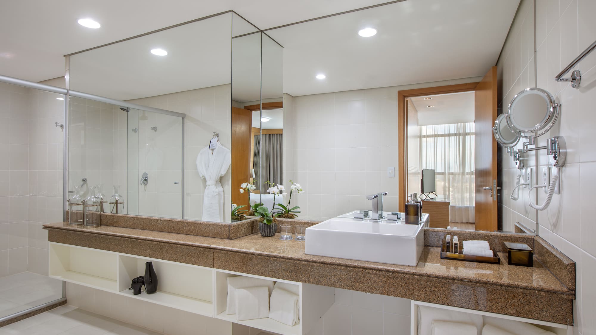 a bathroom with a large mirror and a sink