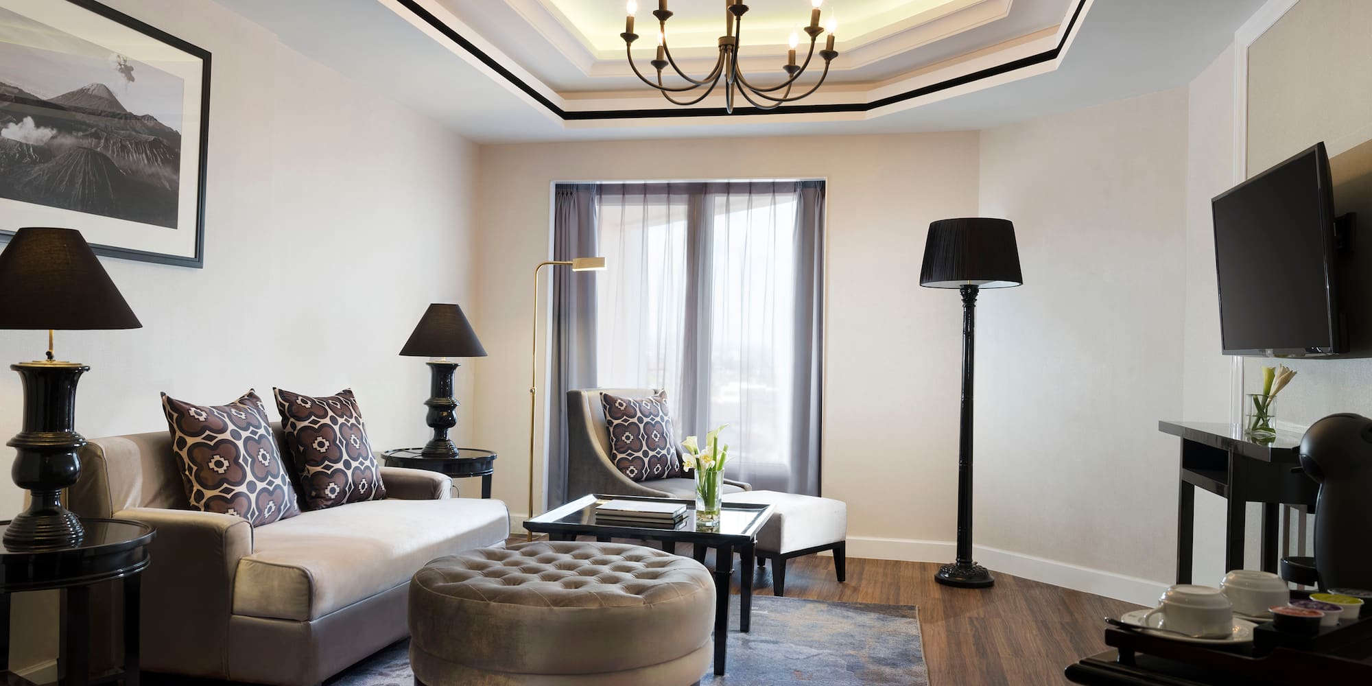 a living room with a chandelier and couches