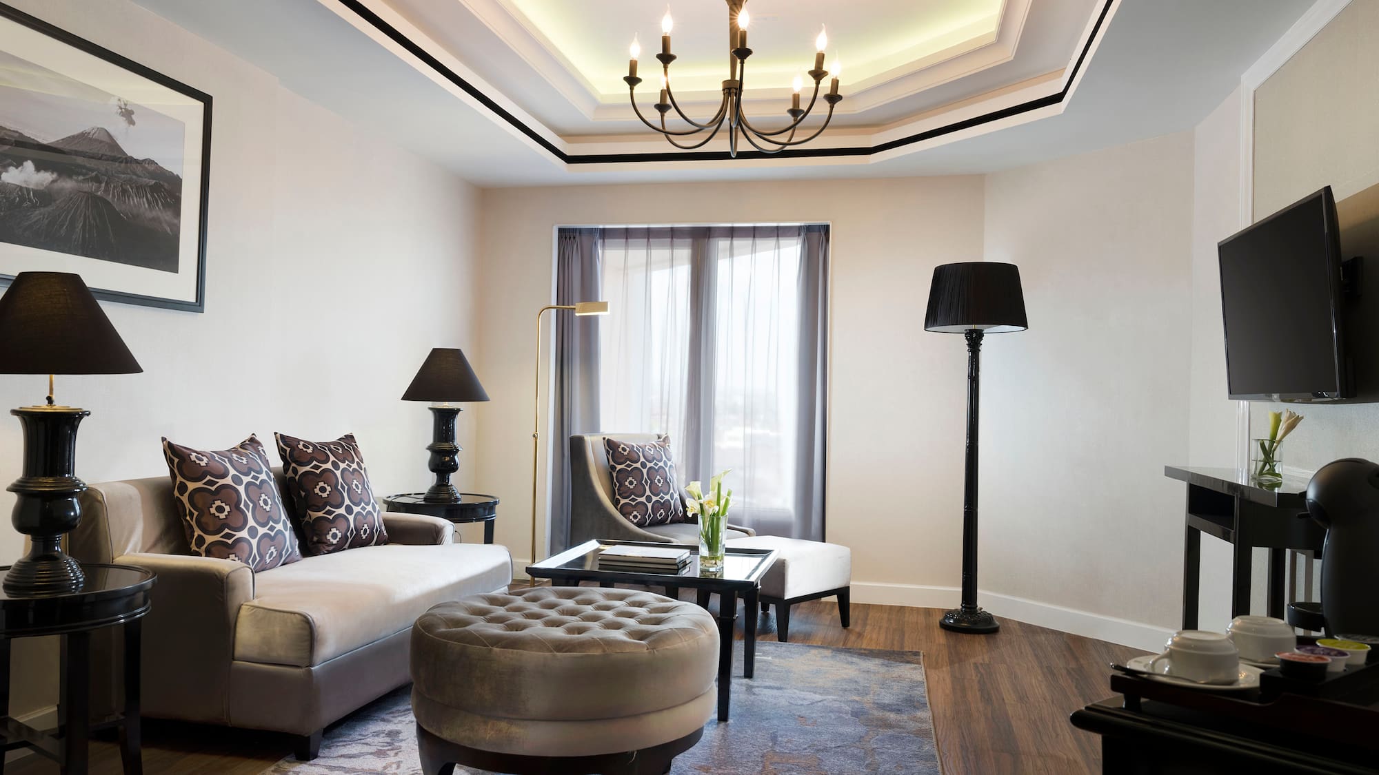 a living room with a chandelier and couches