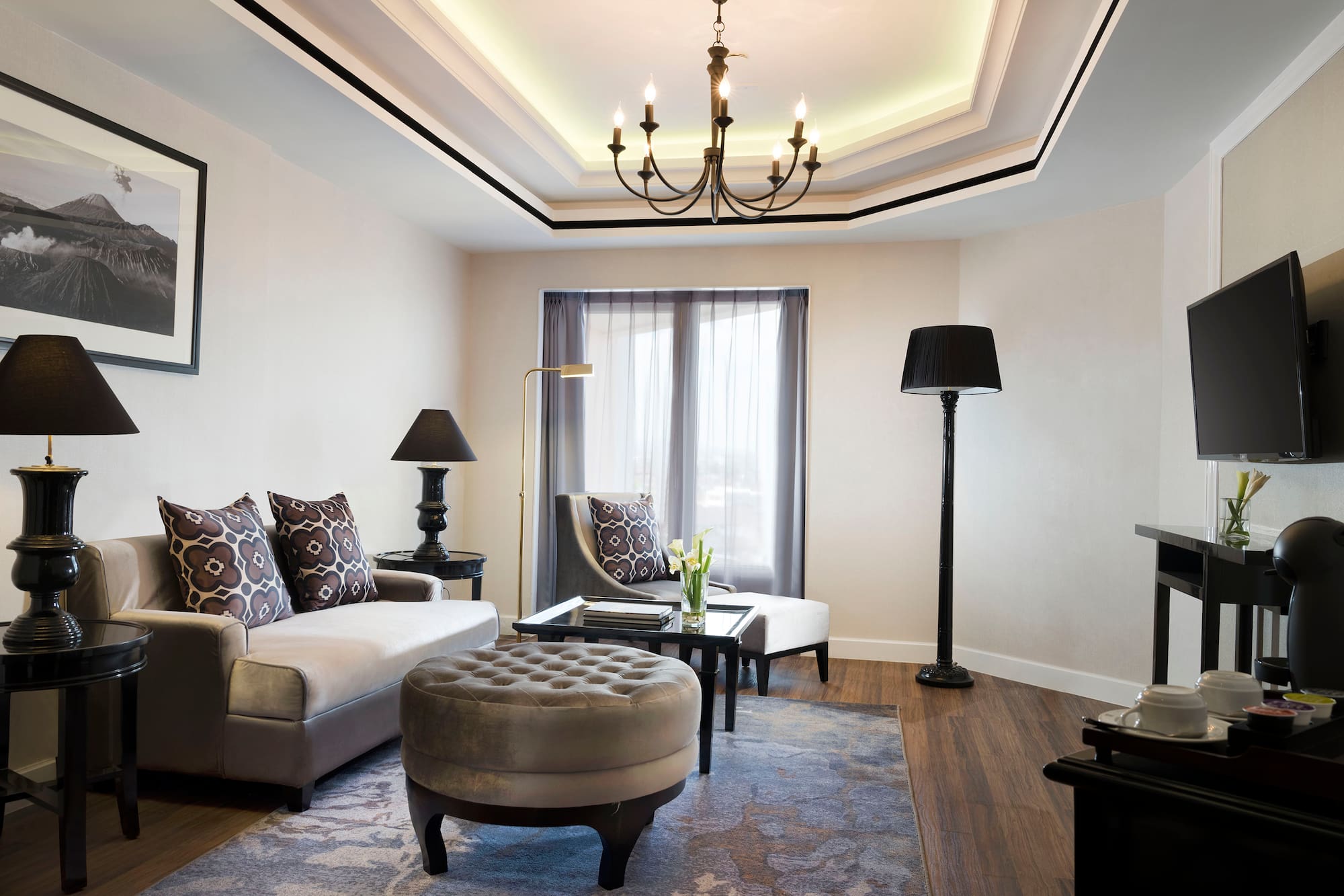 a living room with a chandelier and couches