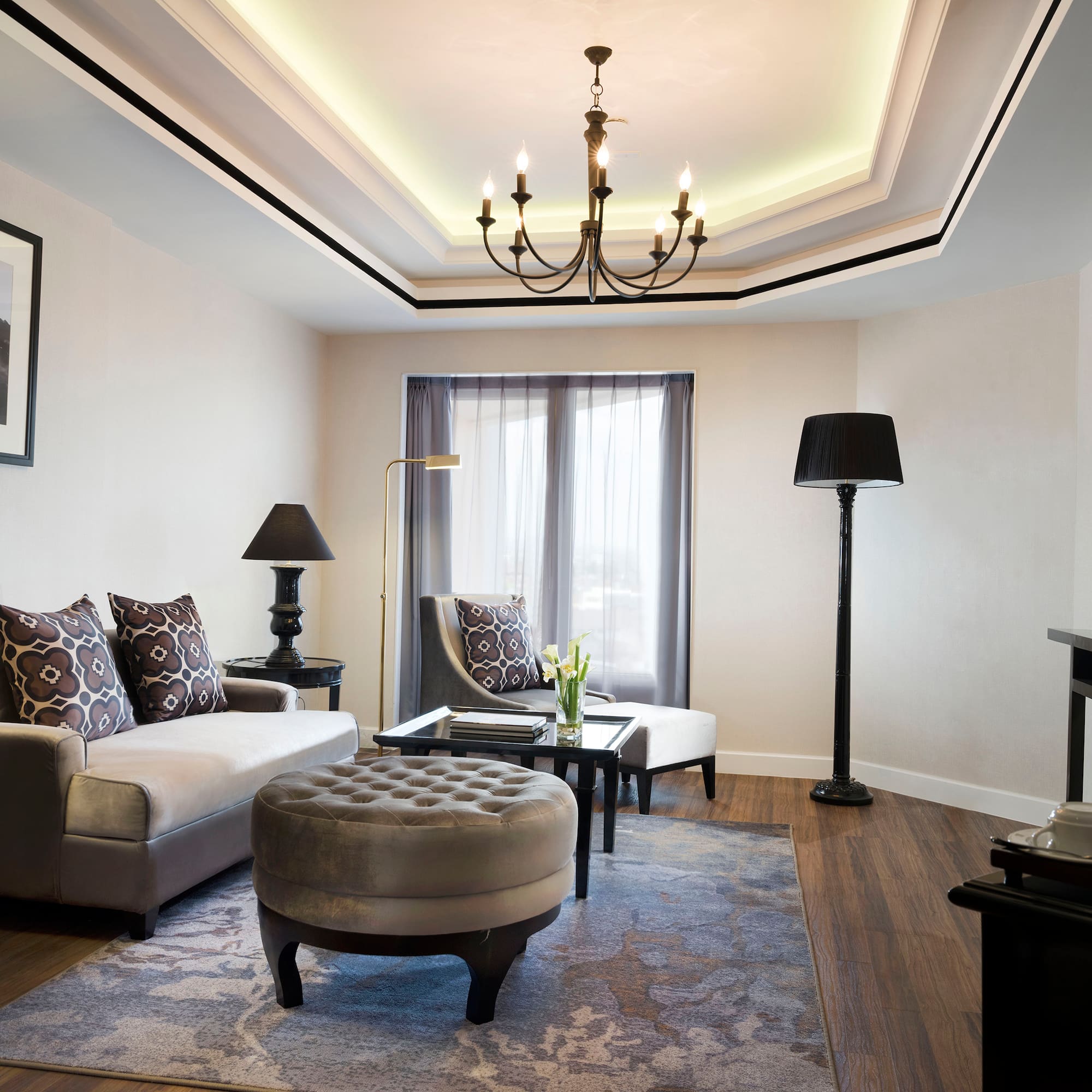a living room with a chandelier and couches
