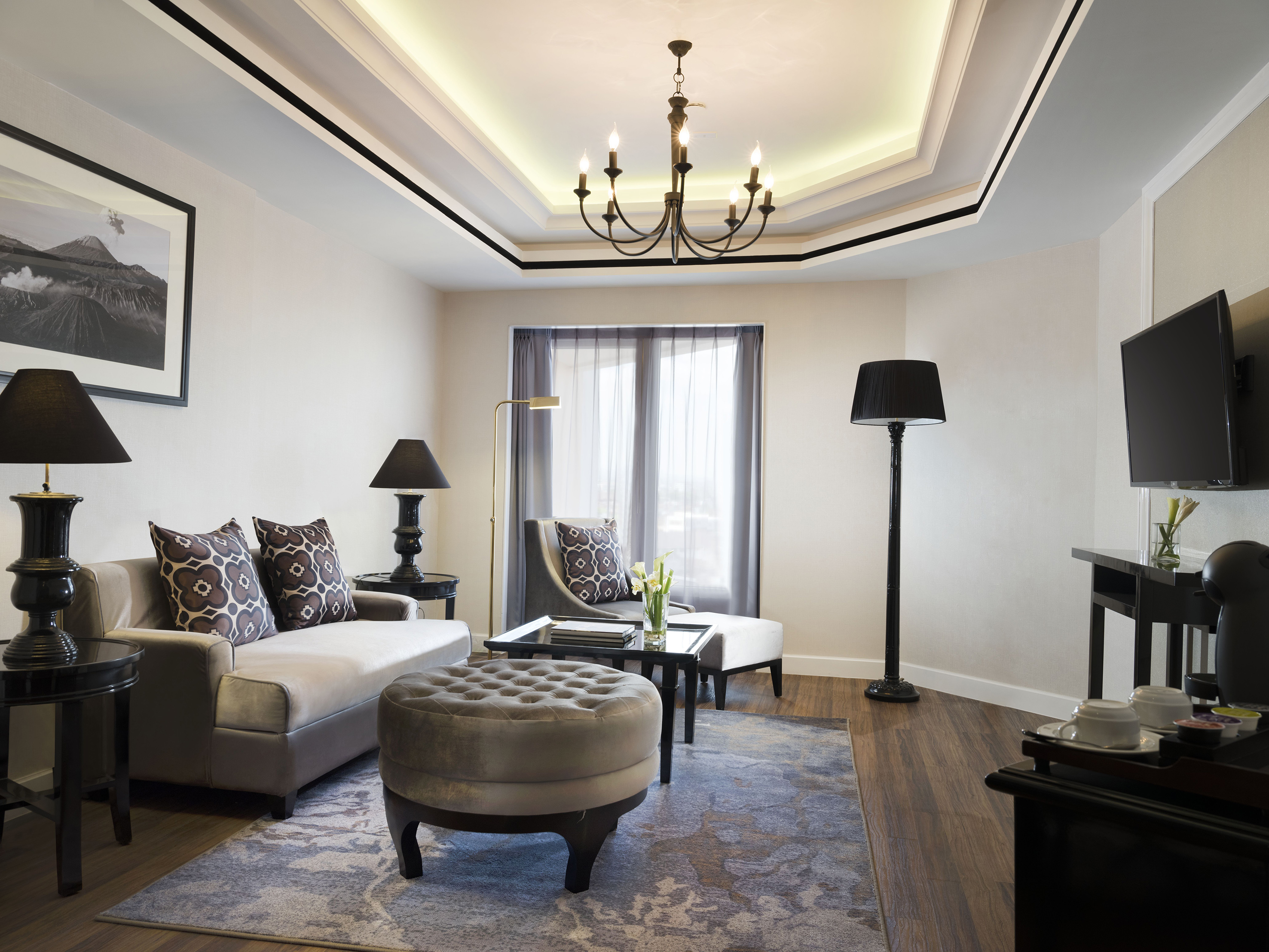 a living room with a chandelier and couches