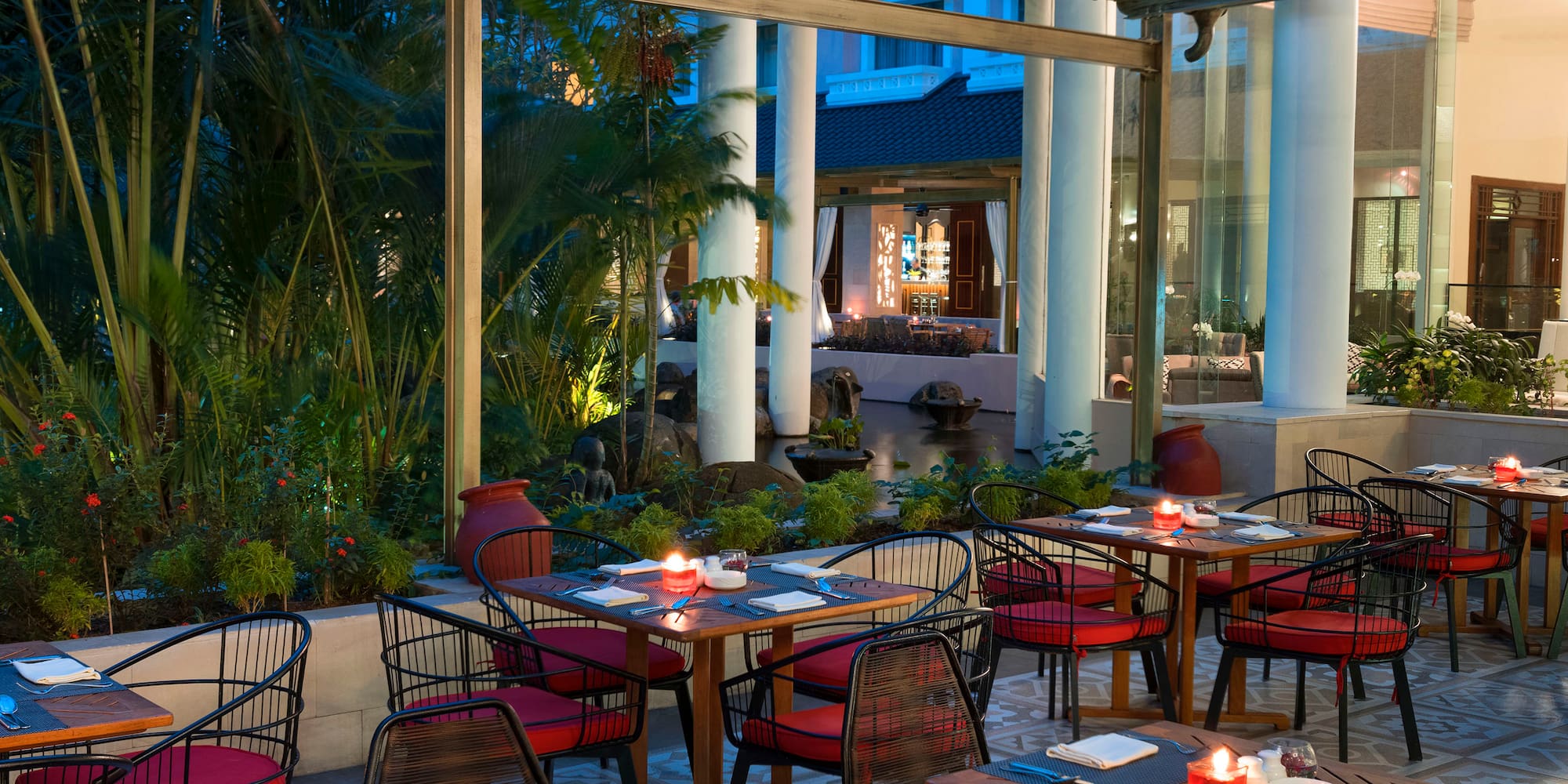 tables outside a restaurant with red and white striped chairs and tables