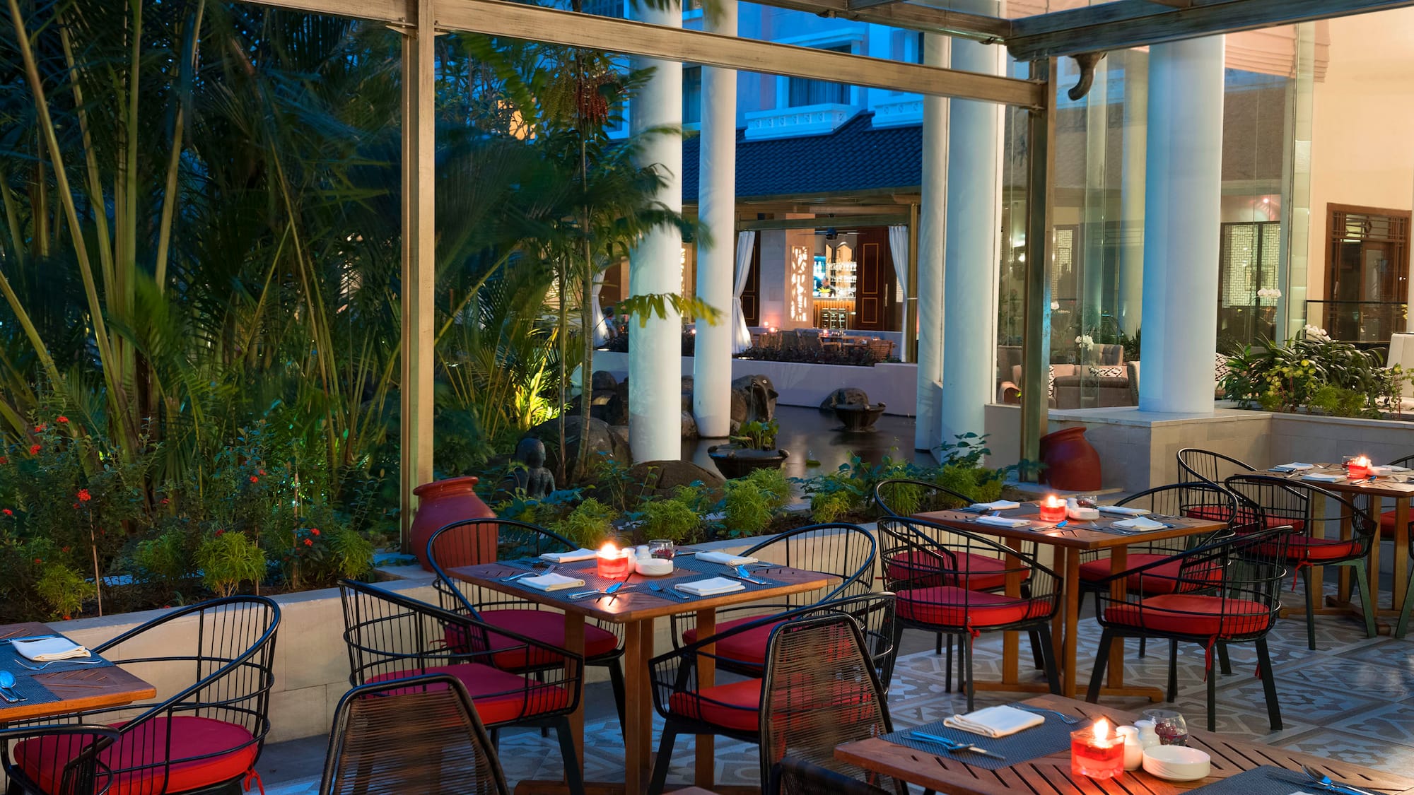 tables outside a restaurant with red and white striped chairs and tables