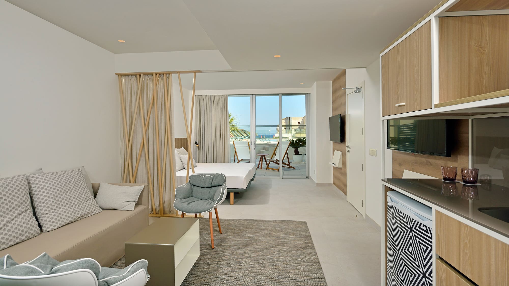 a room with a bed and a television