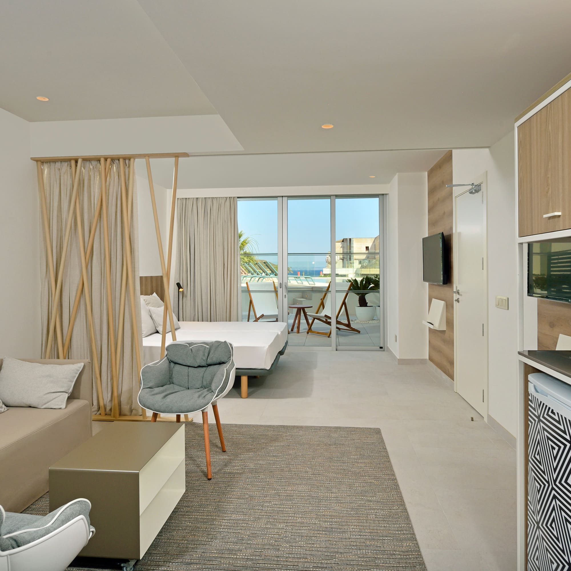 a room with a bed and a television