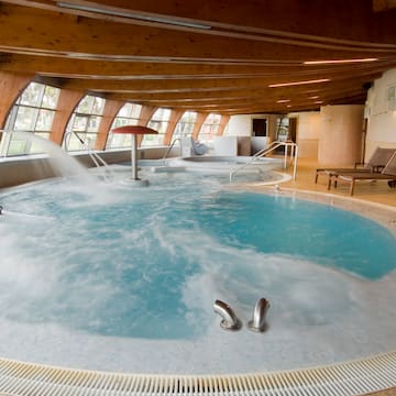 a large indoor hot tub with water coming out of it