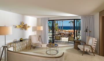 a room with a view of the ocean and a beach